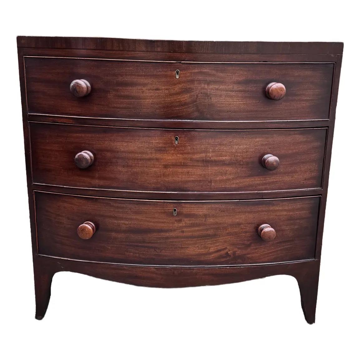 This beautiful 19th century walnut two over two bowfront chest has a rich warm patina with the original wooden pulls. This is what we call a caddy top chest which means the top doesn't over hang which gives its a cleaner more sophisticated
