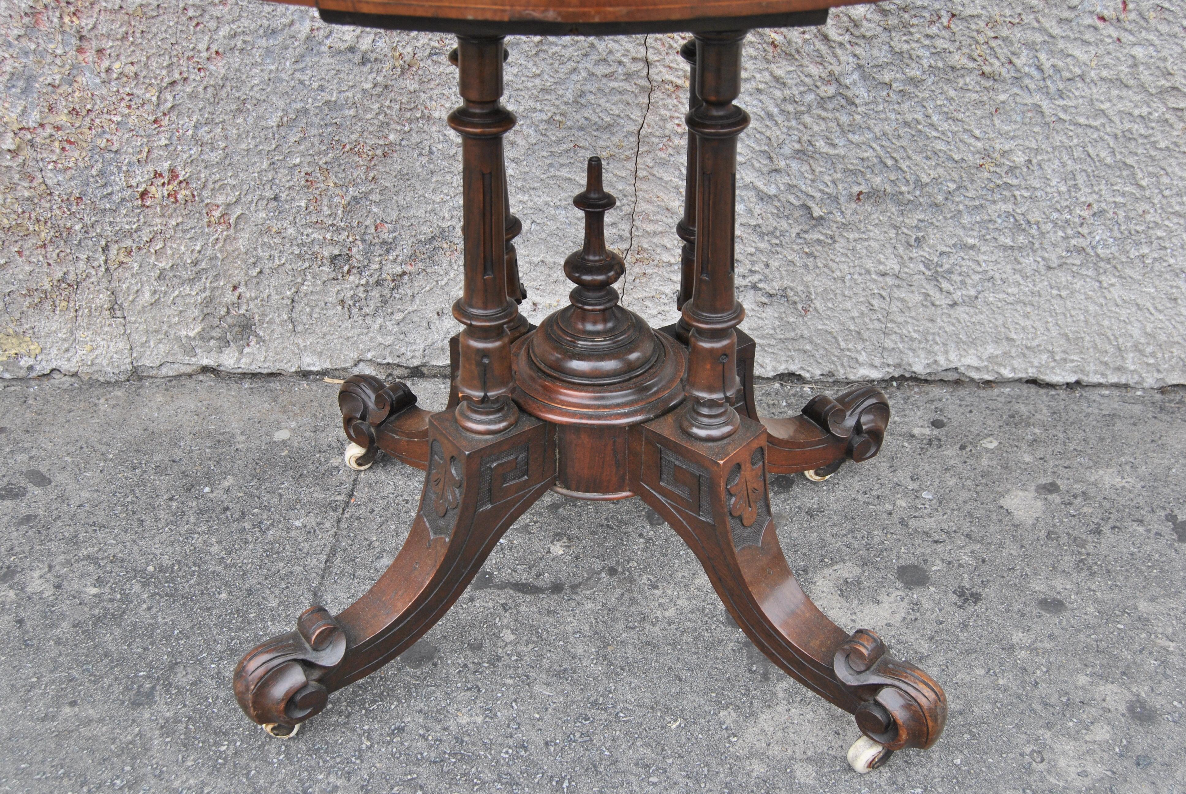 This is a game / card table made in England, circa 1870. The demi-loon top (half circle) top has a nicely molded edge with a beautiful, highly figured cut of Burr Walnut that has a wonderful decorative satinwood Inlay. The base is well turned and