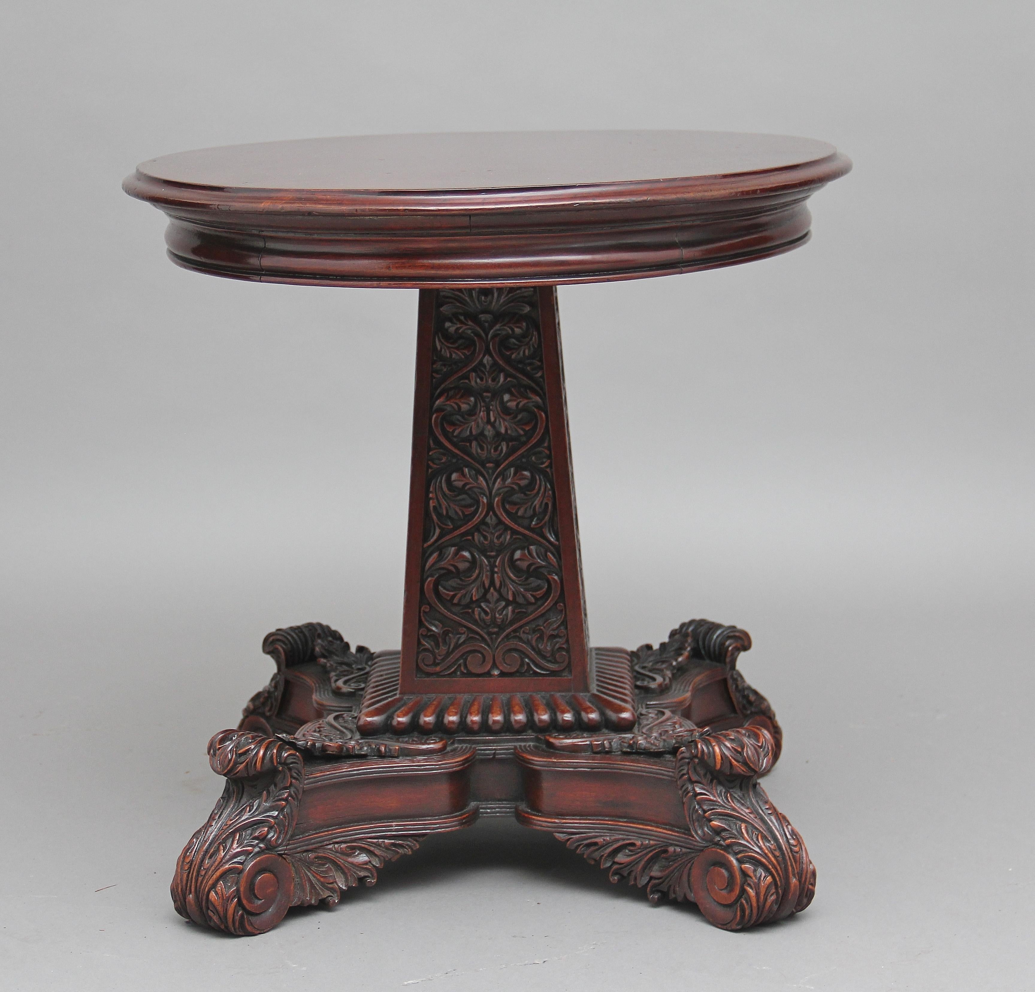 An impressive 19th century walnut carved occasional / coffee table, the molded edge oval top sitting on a fantastic highly carved base, the square tapering column having carved floral decoration on each side, with carved bead decoration at the
