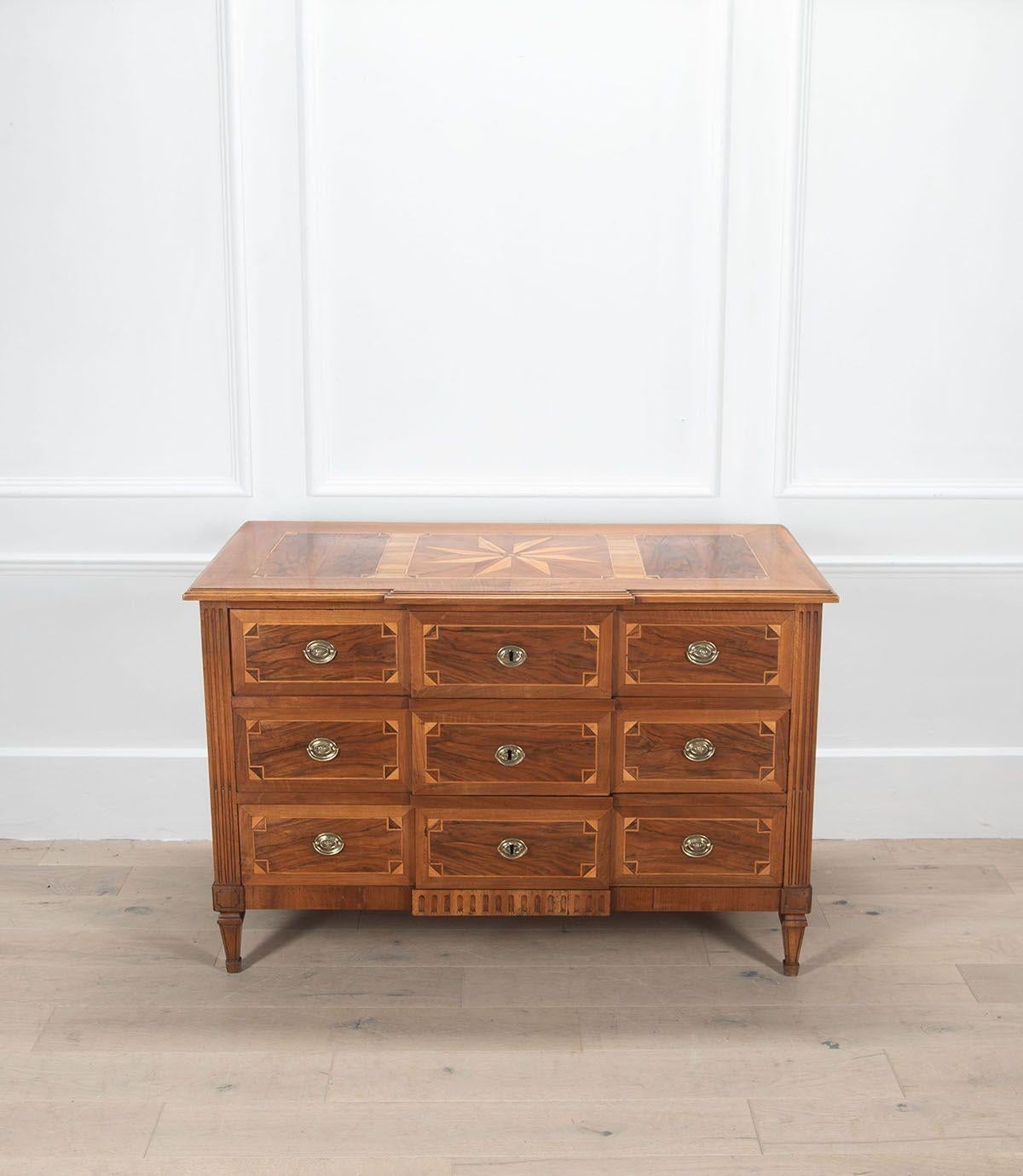 Elegant 19th Century French walnut commode from the Alsace region.
With parquetry inlay and star on the top. It has three drawers finishing on tapered legs.
The commode been cleaned and polished.
Circa 1800.