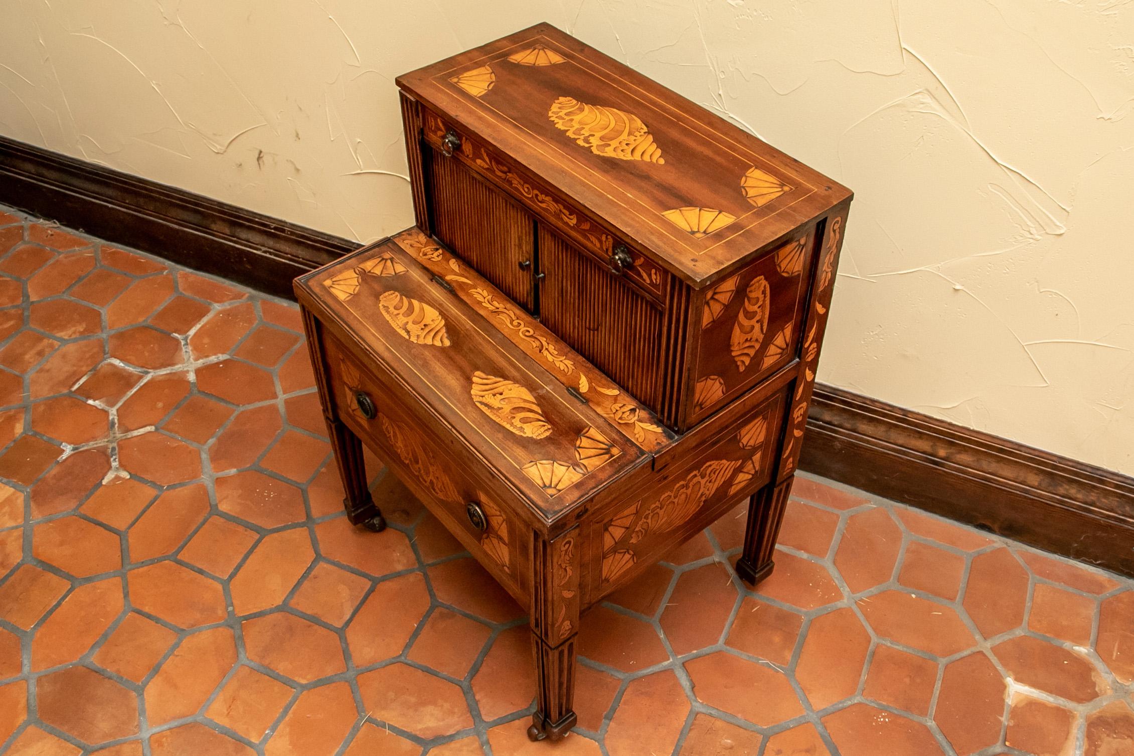 19th century commode, walnut with contrasting shell, scroll and floral form inlaid veneer, top with long narrow drawer over two tambour doors that slide open to reveal a large storage compartment, lower portion with flip-top and large drawer that