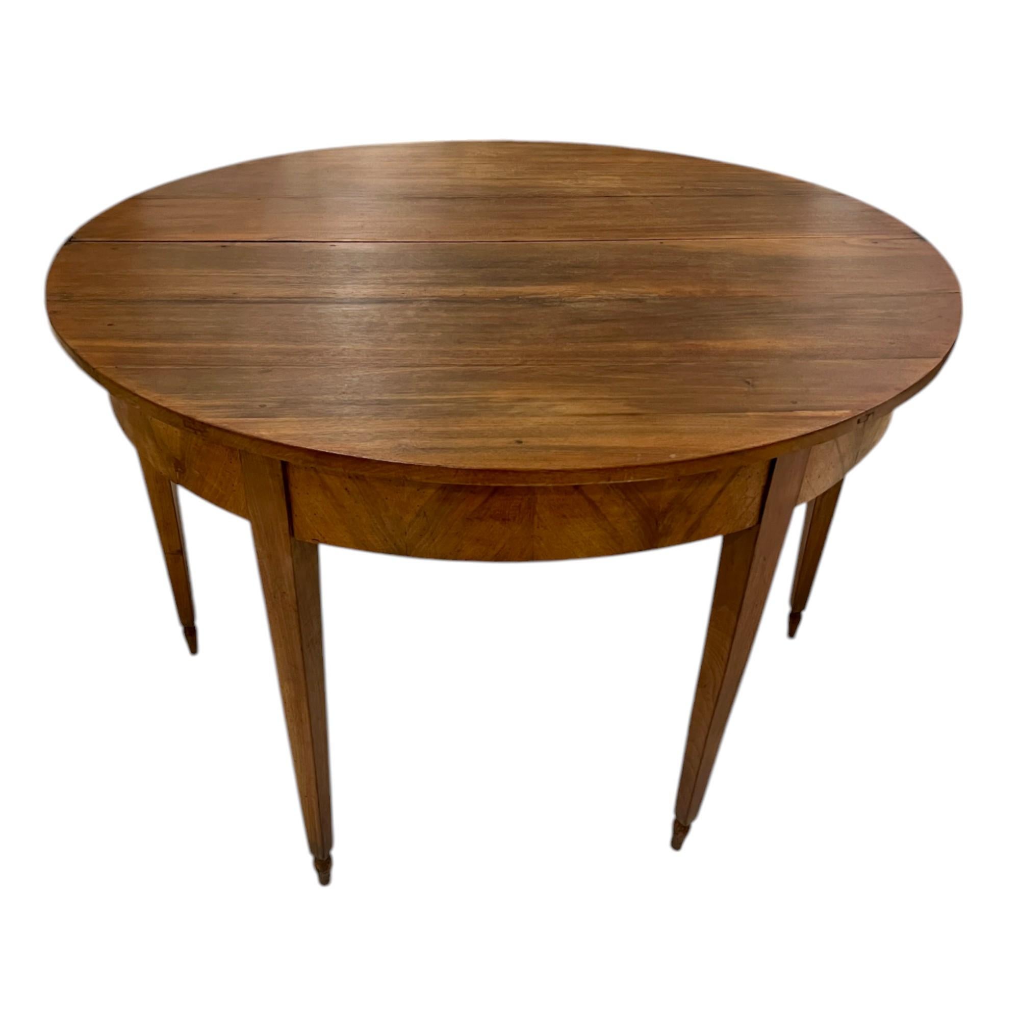 This exquisite 19th Century Walnut Directoire Table embodies the elegance and refinement of the French Directoire period. With its clean lines, subtle detailing, and timeless craftsmanship, this table is a perfect representation of late 18th to