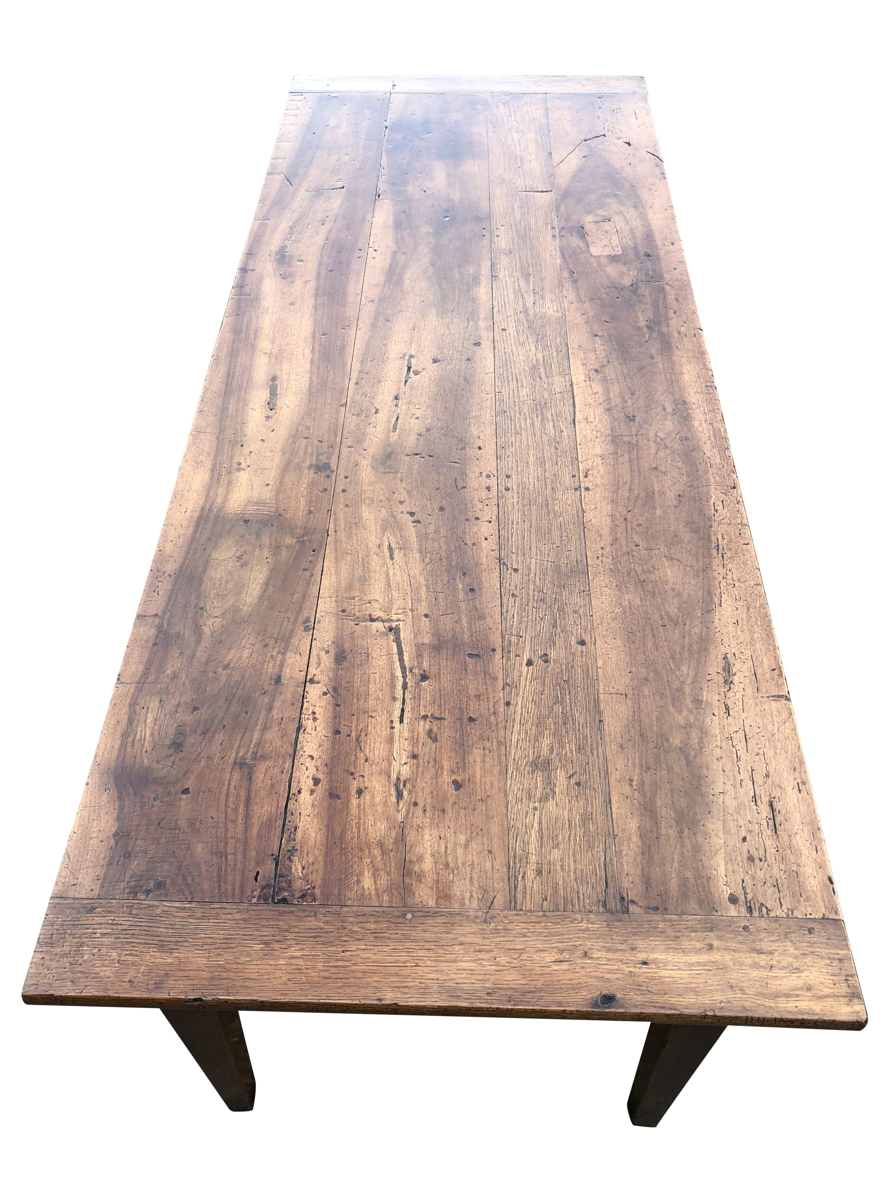 Beautifully figured French walnut and fruitwood farmhouse table with centre drawer.