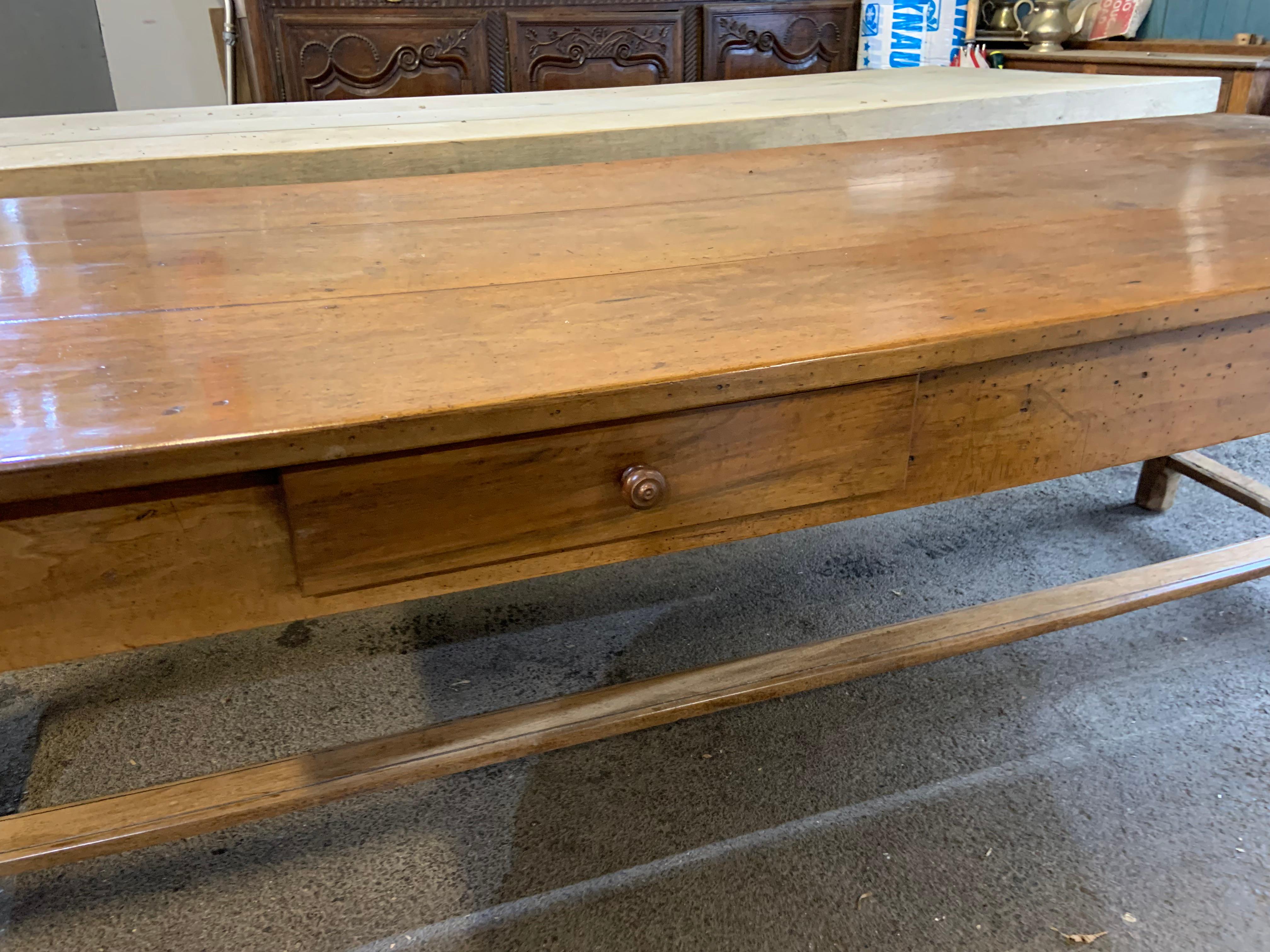 19th Century walnut farmhouse table with two drawers and beautiful original three plank top and cleated ends. The table has two lovely drawers one on either side. The table sits on a sturdy original h stretcher base. Glorious colour. The table is