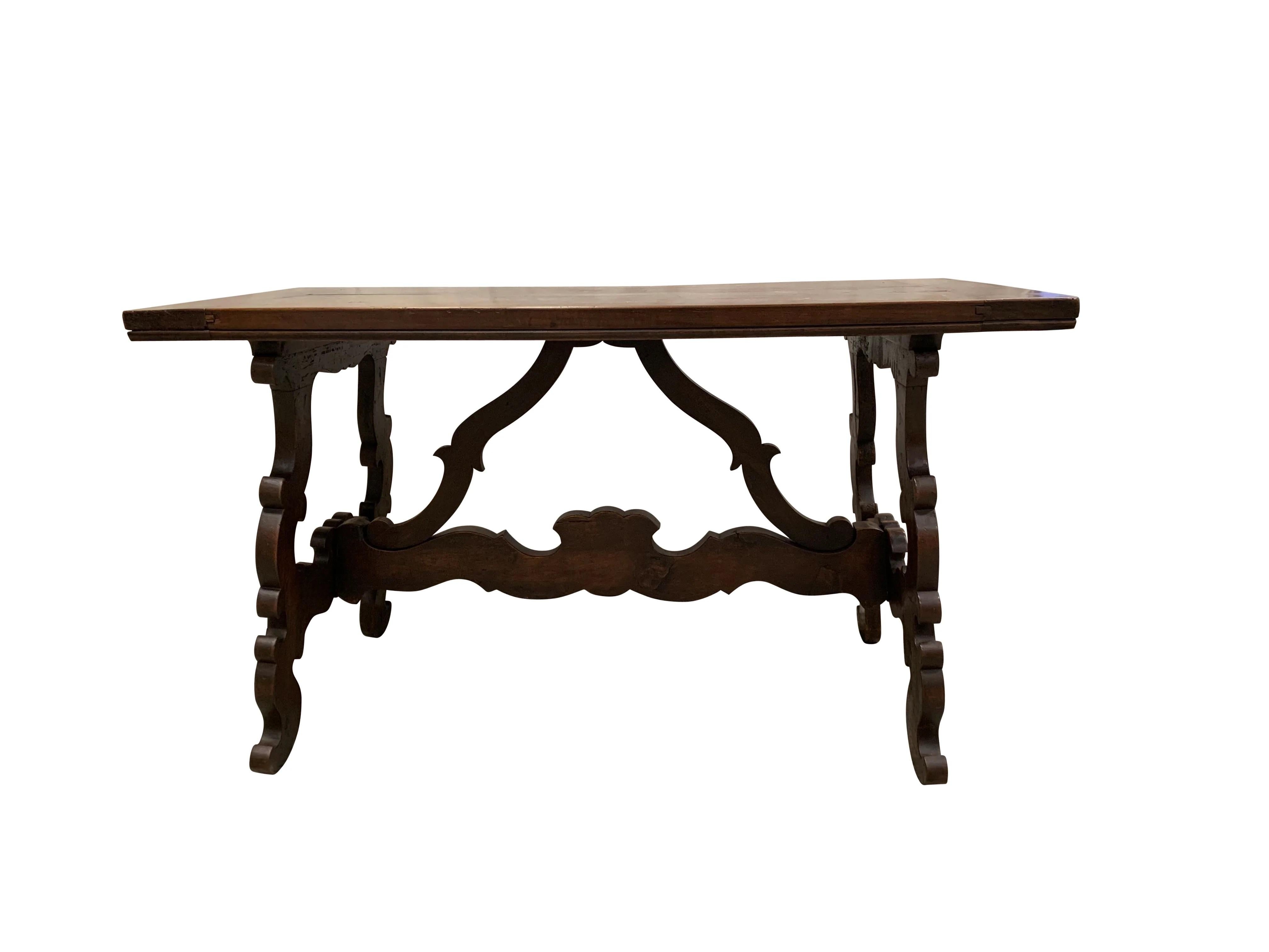 A Walnut Fratino Table from the late 19th century. Featuring a rectangular top, the table is raised on four Baroque style lyre shaped legs that is connected by a beautifully carved cross stretcher. Perfect to place against a wall in a foyer,