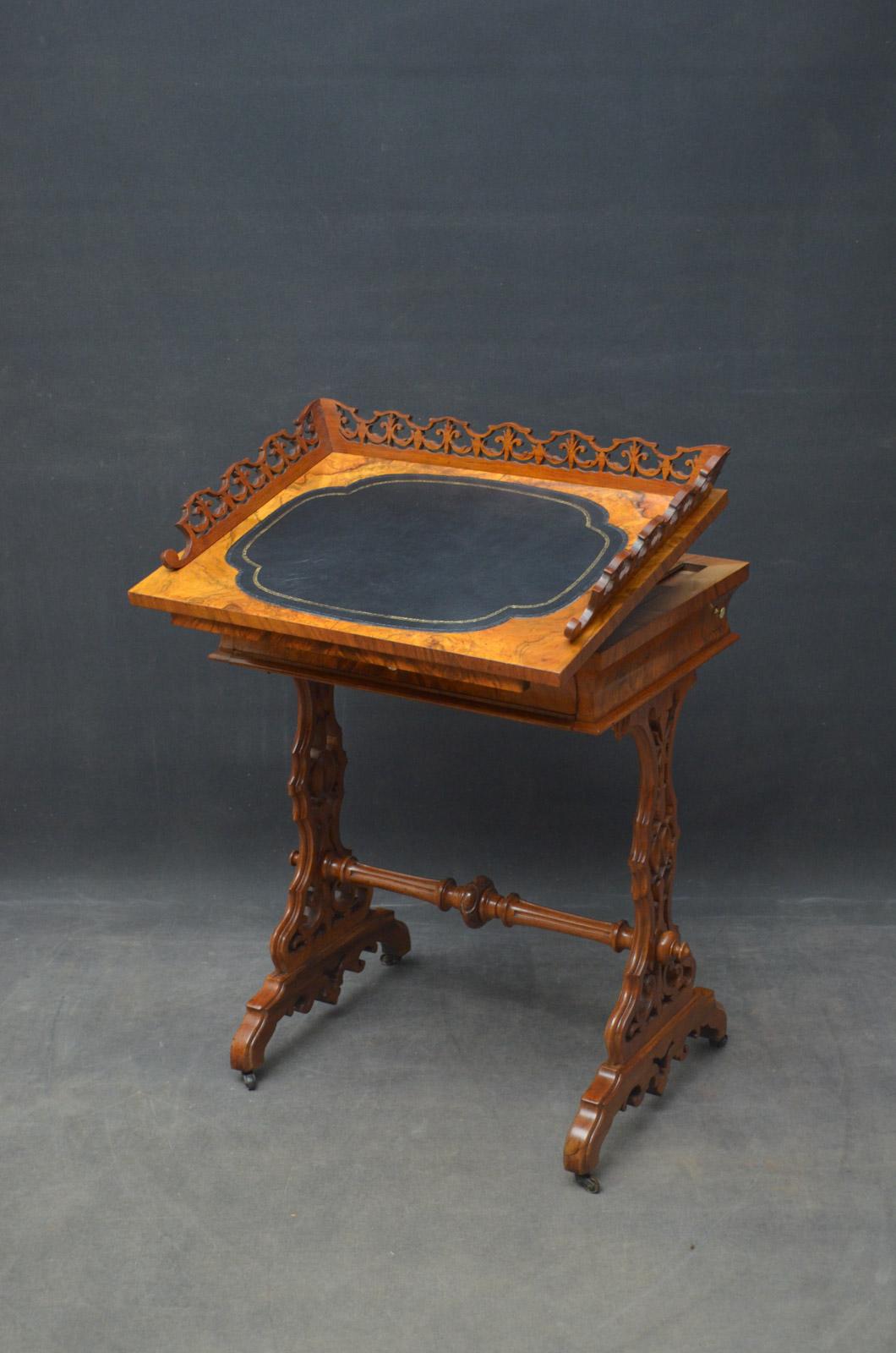 Sn4628, unusual 19th century figured walnut writing table with side drawer, having fretwork gallery and leather writing surface to the top, above a concave drawer and chess and backgammon board, standing on finely carved supports united by turned