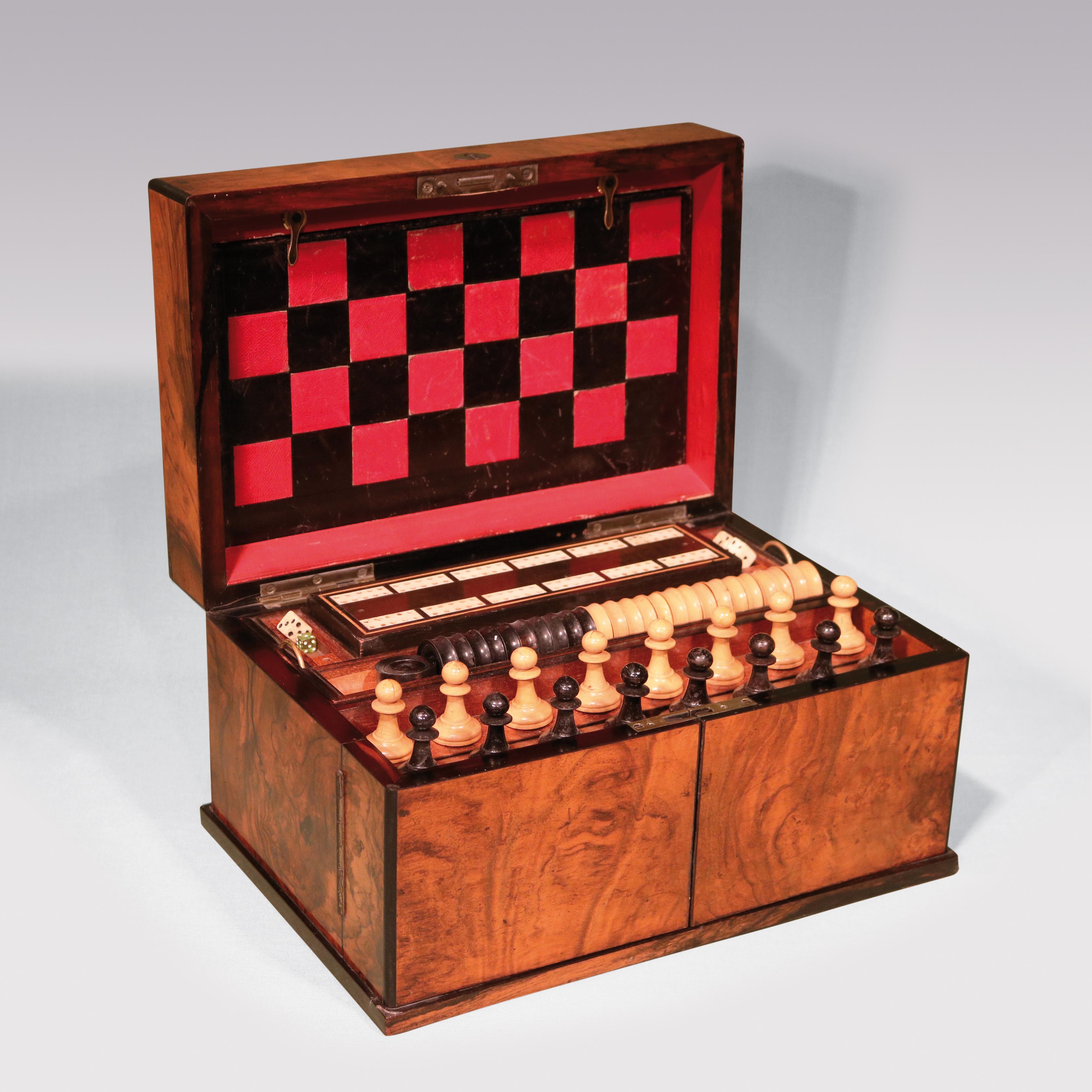 The ‘Royal Cabinet of Games’ by Charles Henry, 22 King Street, Manchester, constructed in figured walnut with coromandel edging, enclosing various games including chess, backgammon & cribbage etc. with red & black leather playing boards.