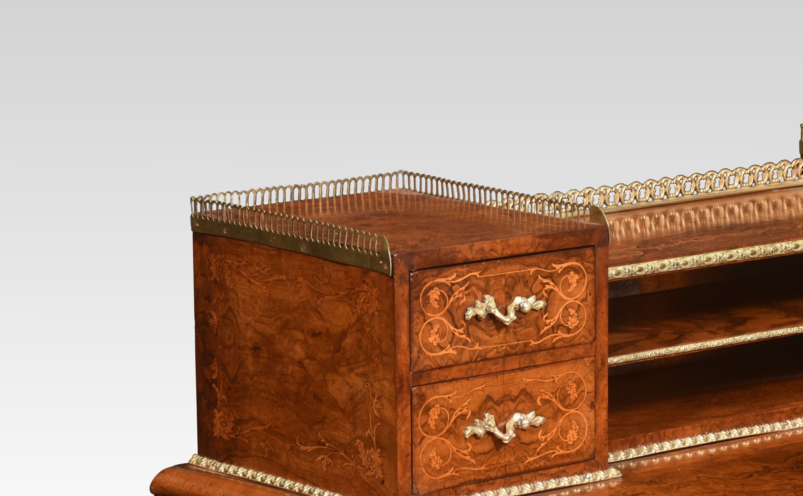 19th-century walnut writing table of serpentine form, the raised superstructure top with fitted shelves and brass gallery, flanked by two banks of drawers. To the well figured serpentine top with a molded edge. Above single freeze drawer. Raised up