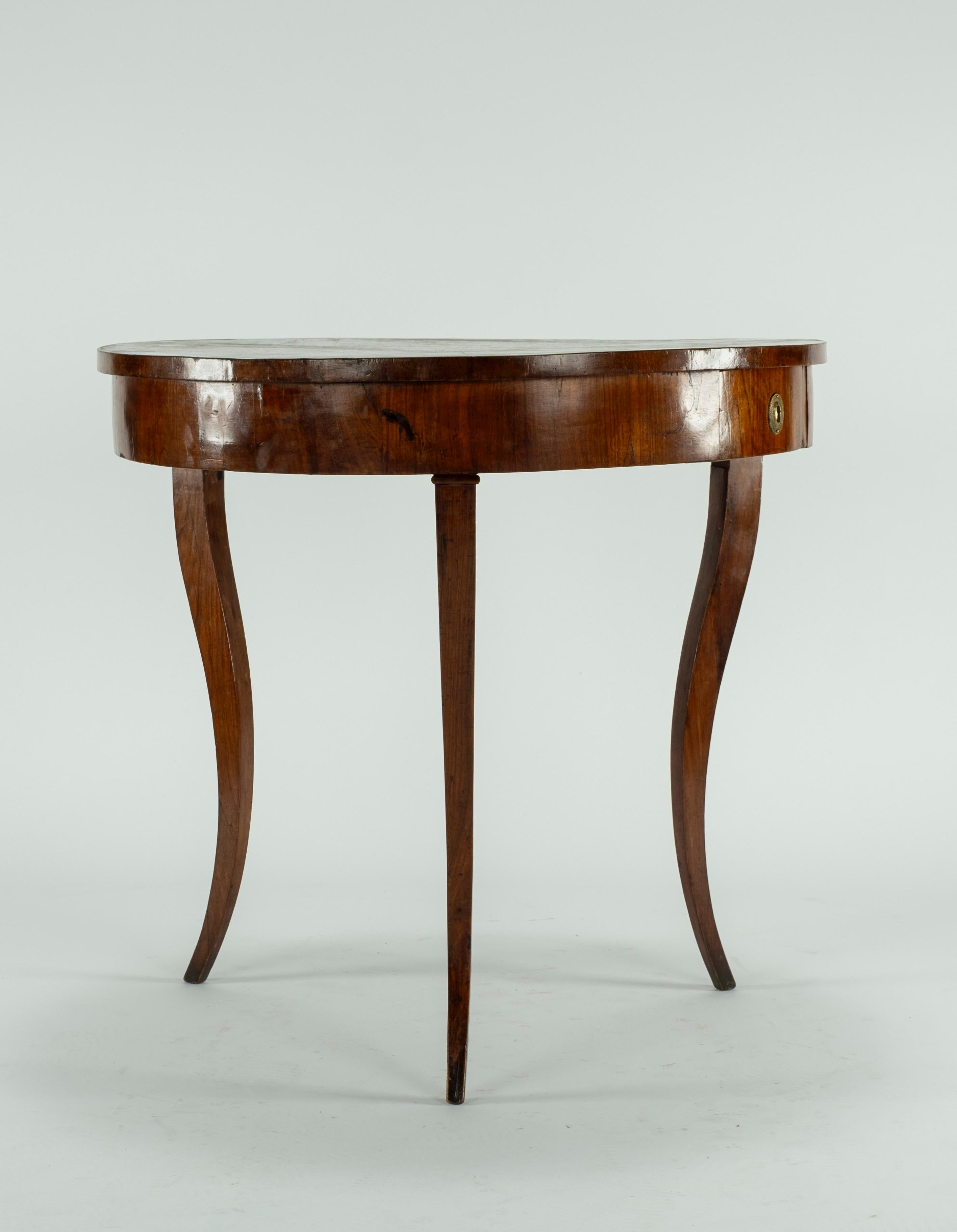 19th century three legged walnut Italian table with a drawer. Exaggerated movement of the legs gives this piece a very elegant and delicate feel. Sturdy piece.