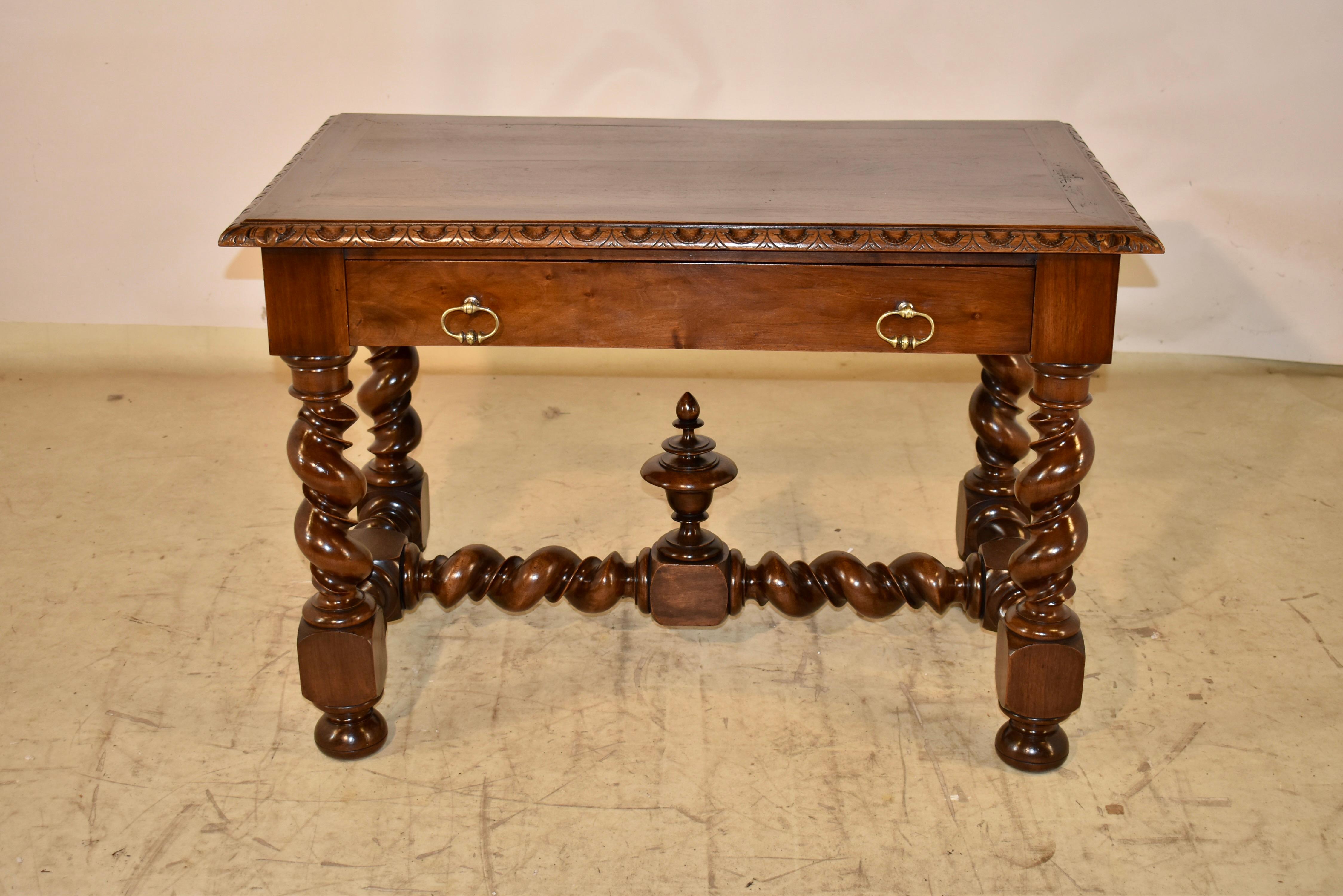 Tavolo da biblioteca in noce di inizio XIX secolo proveniente dalla Francia.  

Il tavolo ha un meraviglioso piano in legno a fasce con un bordo decorato smussato e intagliato, che circonda delle belle tavole centrali con venature.  Conserva