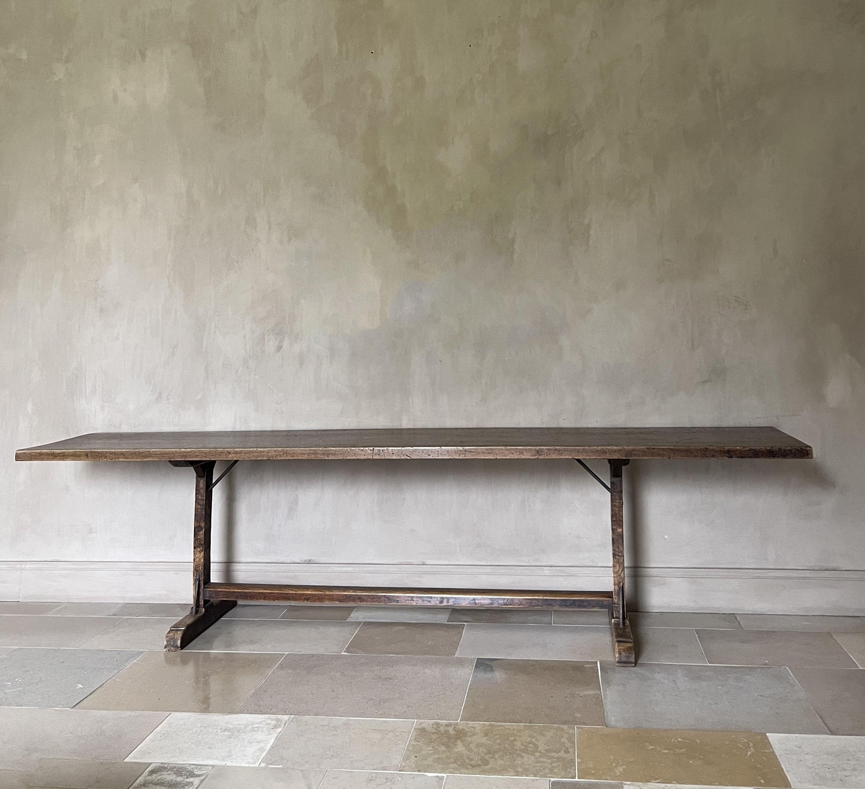 A large 19th century Pyrinee console table. The beautifully patined one slab walnut top on colomn feet in the same wood. Tables like these were made for centuries in largely the same manner. Knowhow and sense for proportion was handed down for