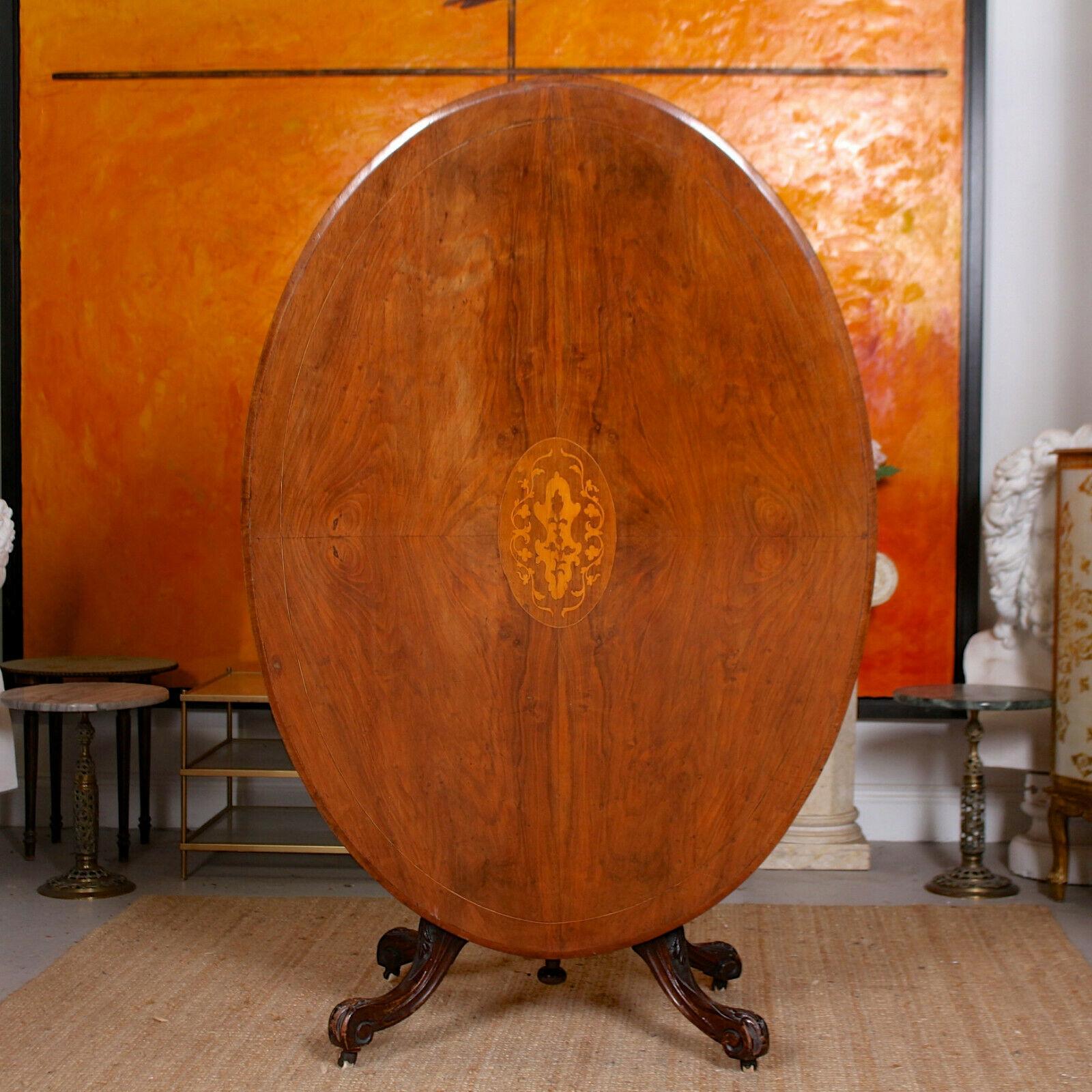 An impressive 19th century rosewood and walnut tilt top breakfast table.
The oval top with fine marquetry work, chamfered edges and raised on a well carved column and acanthus carved quadripartite base terminating in original castors,
England,