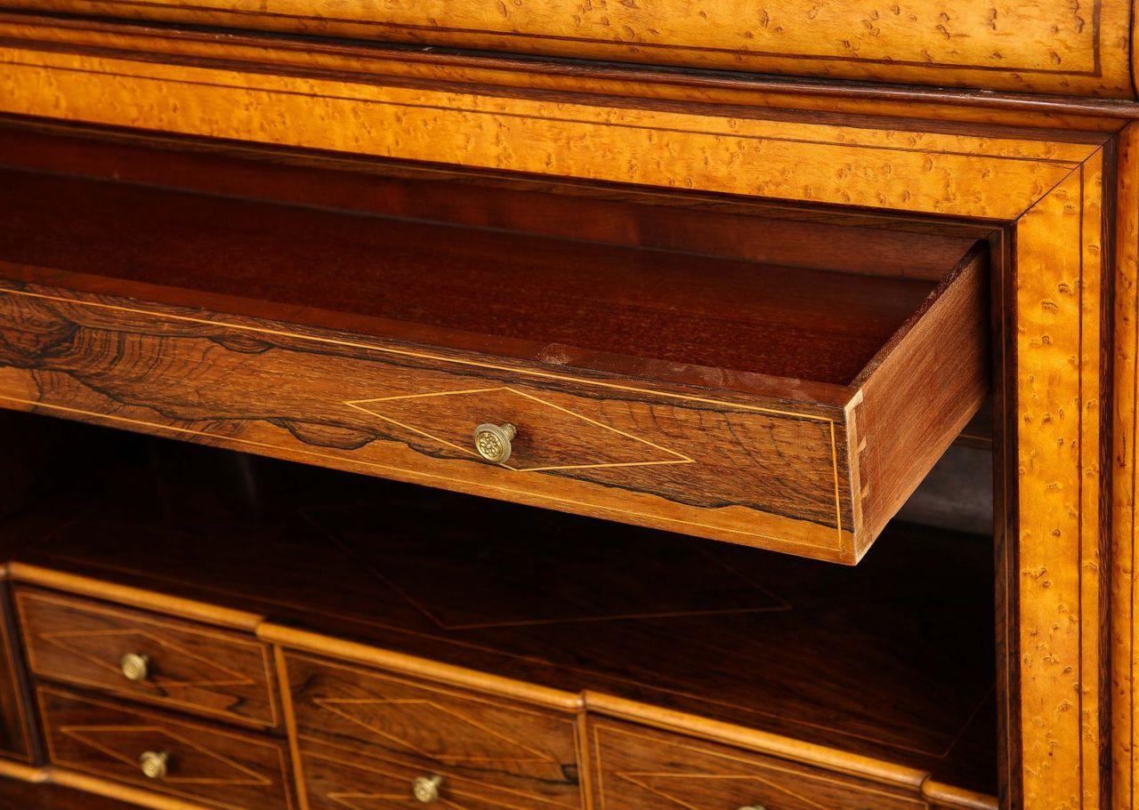 A 19th-century secrétaire abattant of exceptional quality.  This beautiful piece consists of a center cabinet with a tooled leather writing surface and five small drawers and a lower cabinet with shelves. Exquisite details throughout the piece,