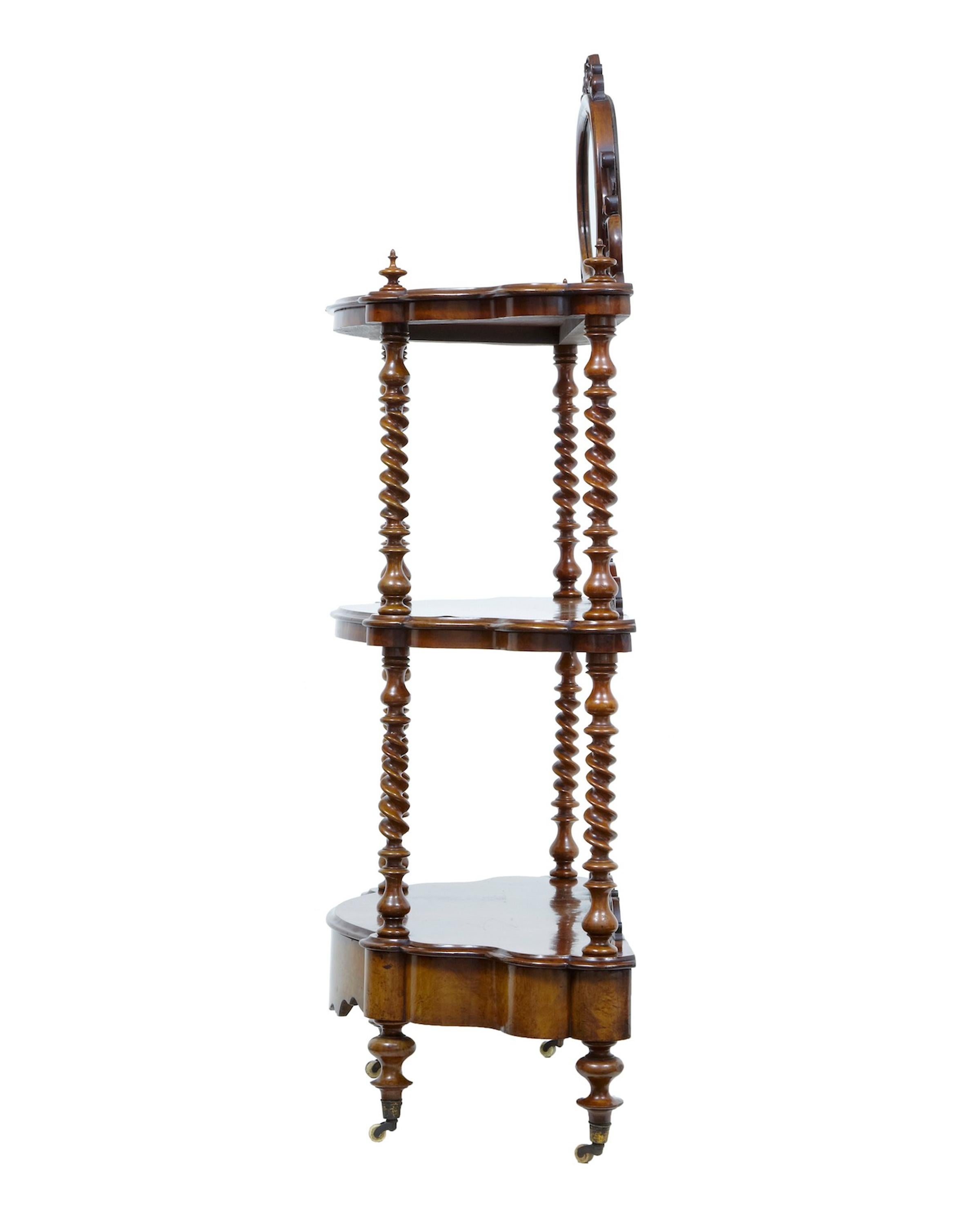 19th century walnut victorian what not stand, circa 1870.

Good quality walnut what not. Beautifully veneered in burr walnut. 3 tiers, top tier with mirror and applied ornate carving. United by turned twists. Drawer in the base, standing on