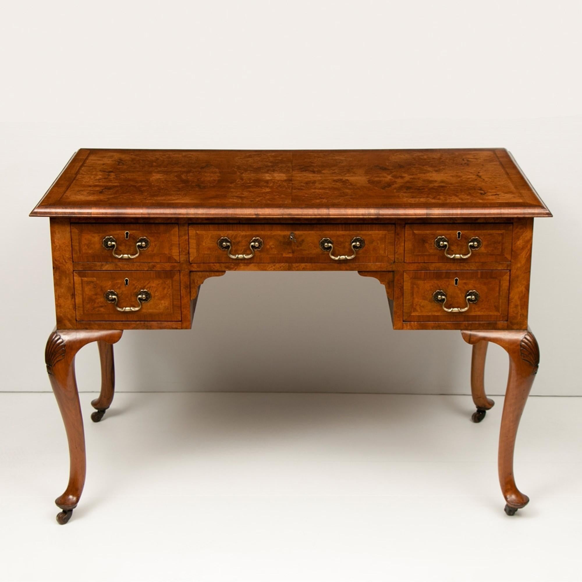 A very good quality circa 1900 walnut Quenne Ann style carved and quarter veneered walnut writing desk. We have completely restored the desk and Hand bespoke French polished the desk and made keys for the locks.

Home ready.