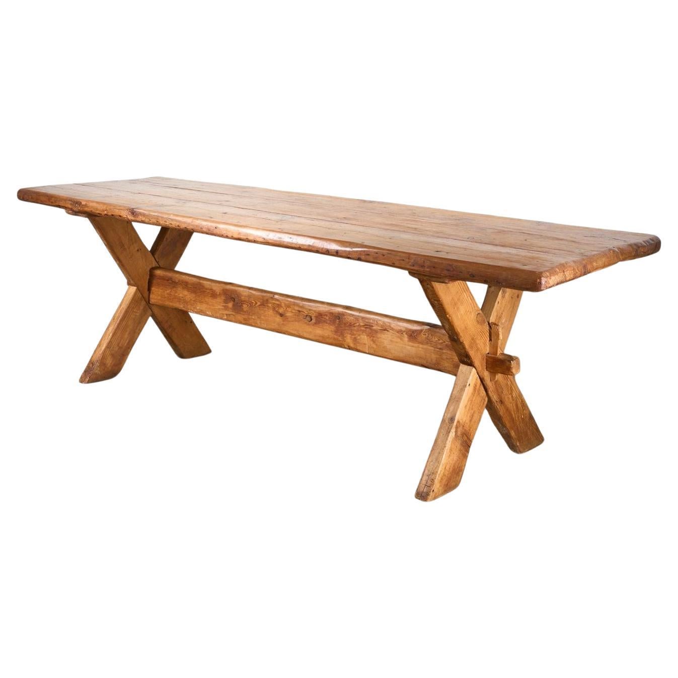 19th Century waney edged pine X frame tavern table For Sale