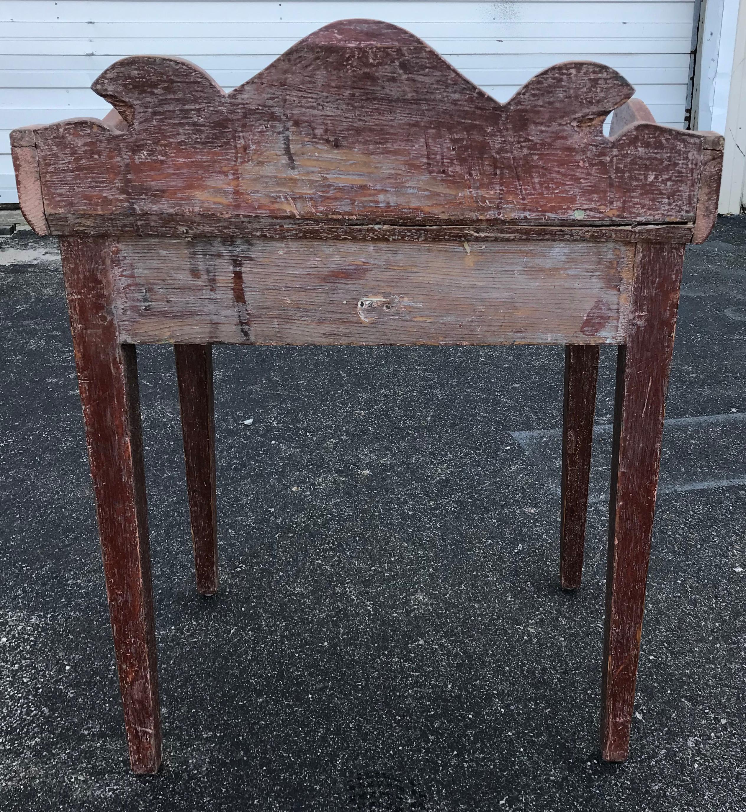 Diminutive 19th century washstand with nicely shaped backsplash, small single drawer and all over old red paint.
