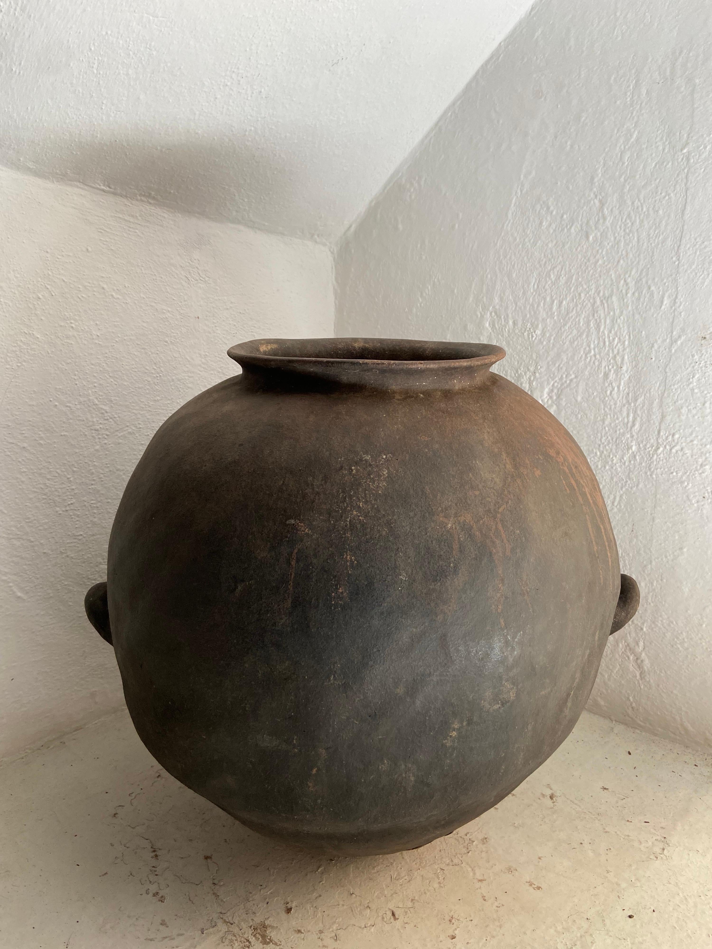 Late 19th century water pot from the highlands of Puebla, Mexico. This style of pottery is indigenous to the Nahua communities of the northern area of the state. The style is furthermore apparent by the wide, rounded body design and low, small
