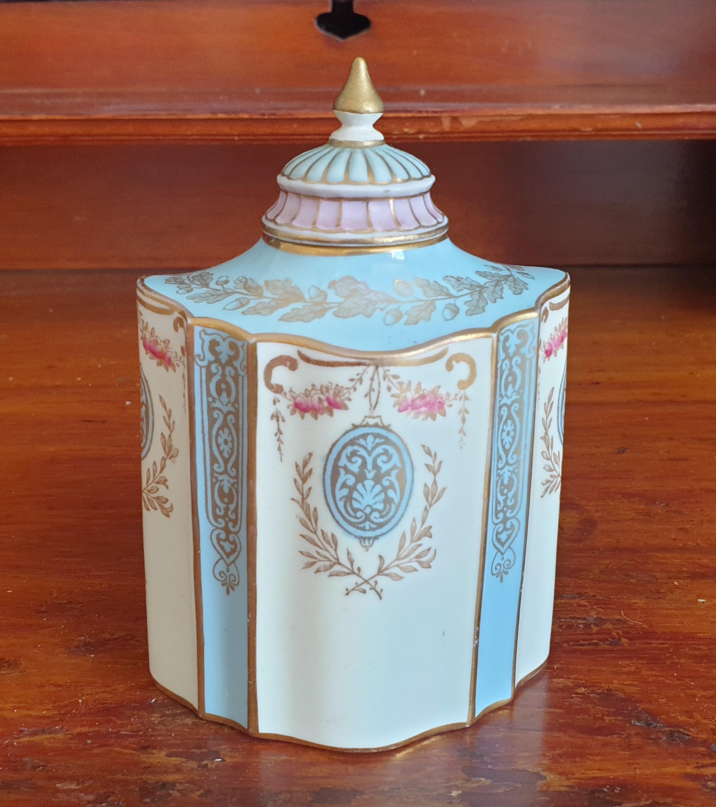 A 19th century Wedgewood tea caddy handpainted with little pink roses, with gilt leaves and gilt dercoration.