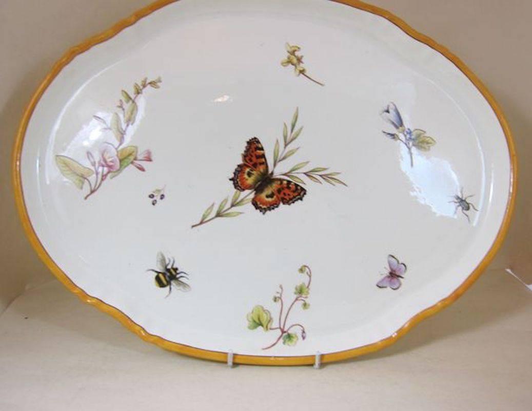 A Wedgwood creamware tête à tête tray, teapot/lid, sucrier/lid, creamer/lid, bowl and two cups/saucers decorated with bugs and flowers.