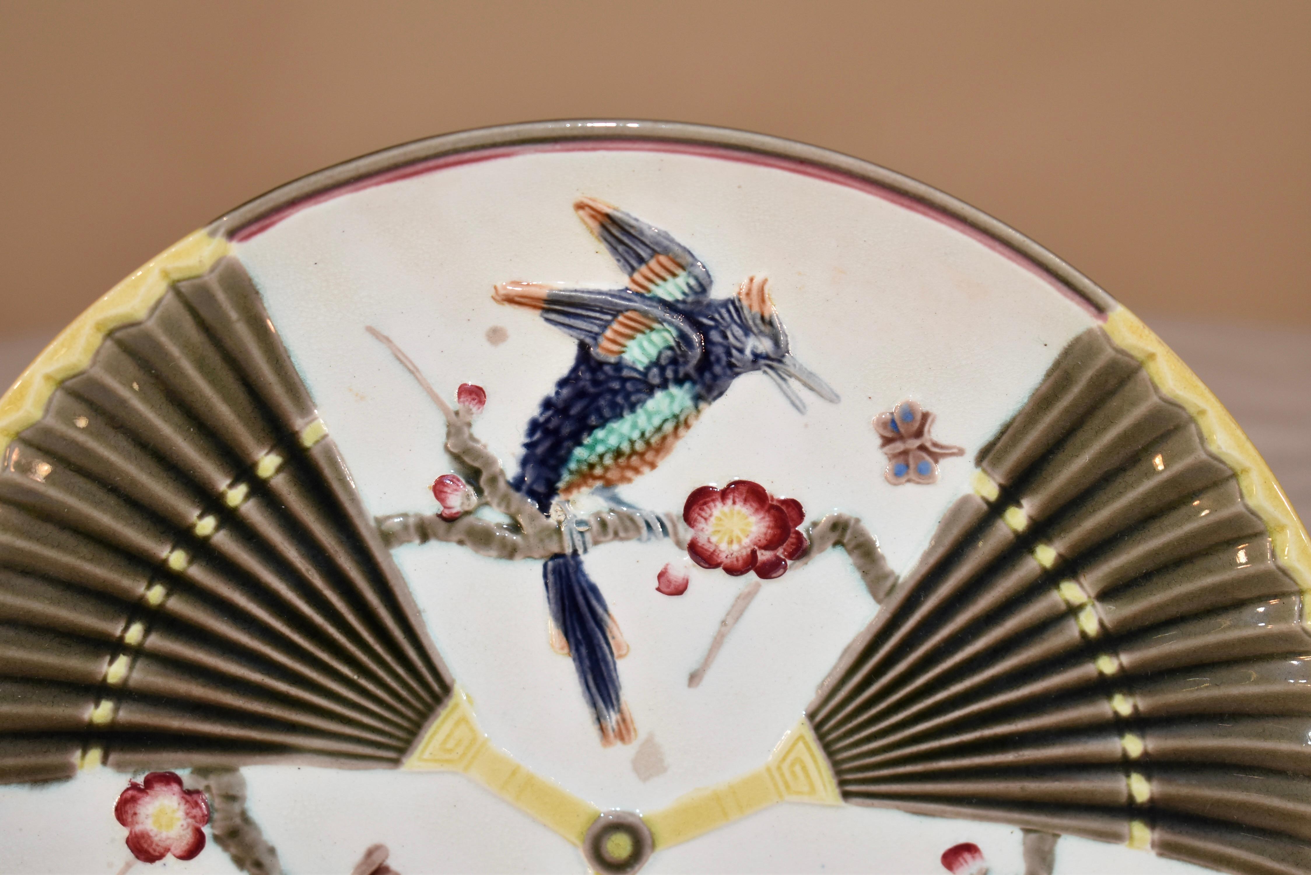 Teller mit Vogel- und Fächermuster aus Majolika aus dem 19. Jahrhundert in England. Auf der Rückseite des Tellers befindet sich eine eingeprägte WEDGWOOD-Marke. Die Farben sind leuchtend und schön. Auf der Rückseite befindet sich ebenfalls eine