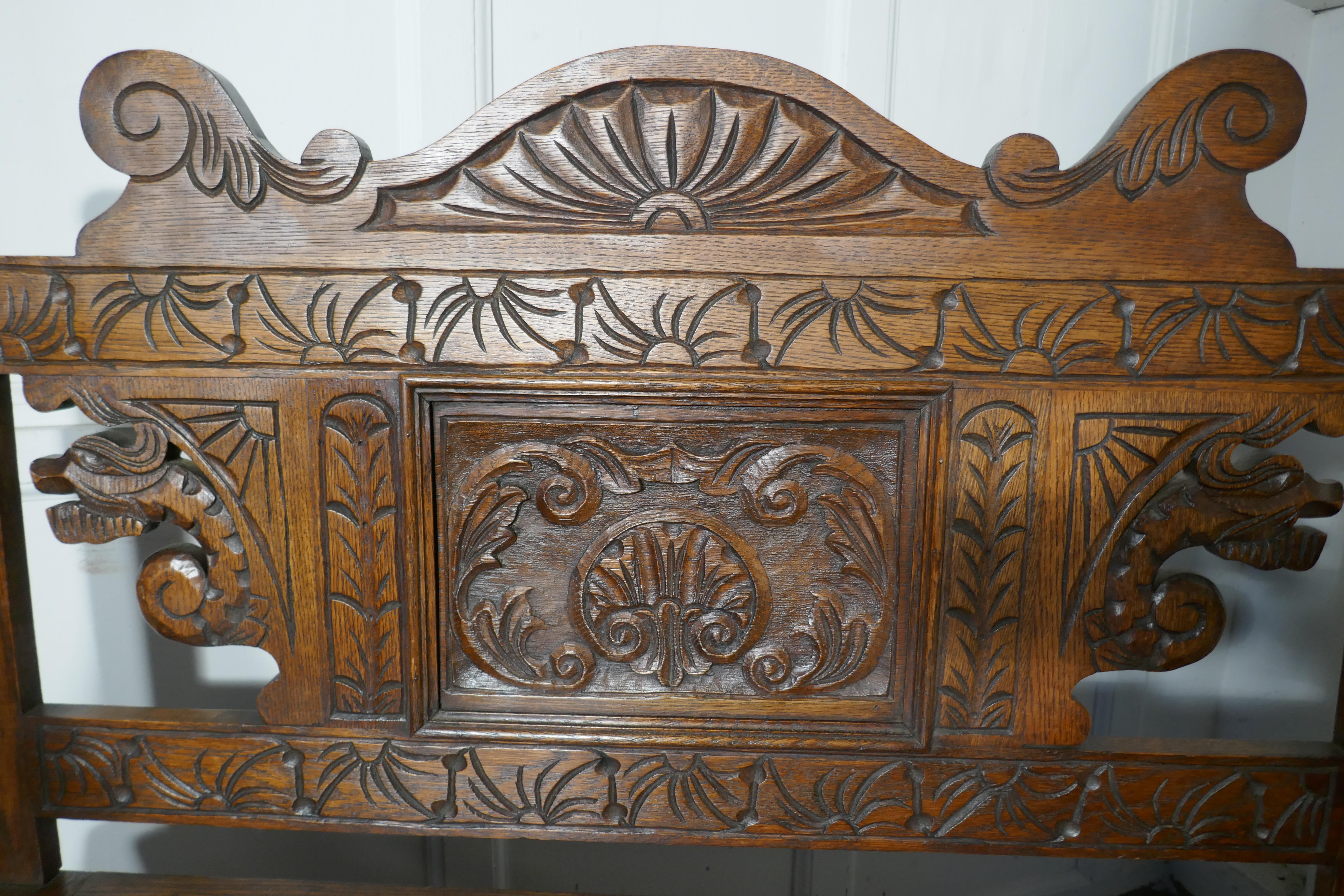 19th century Welsh high back carved oak box settle

The settle has a superbly carved back panel with fierce Dragons, and further carving at the bottom with the geometric and floral patterns, the seat opens for storage
The bench is a real country