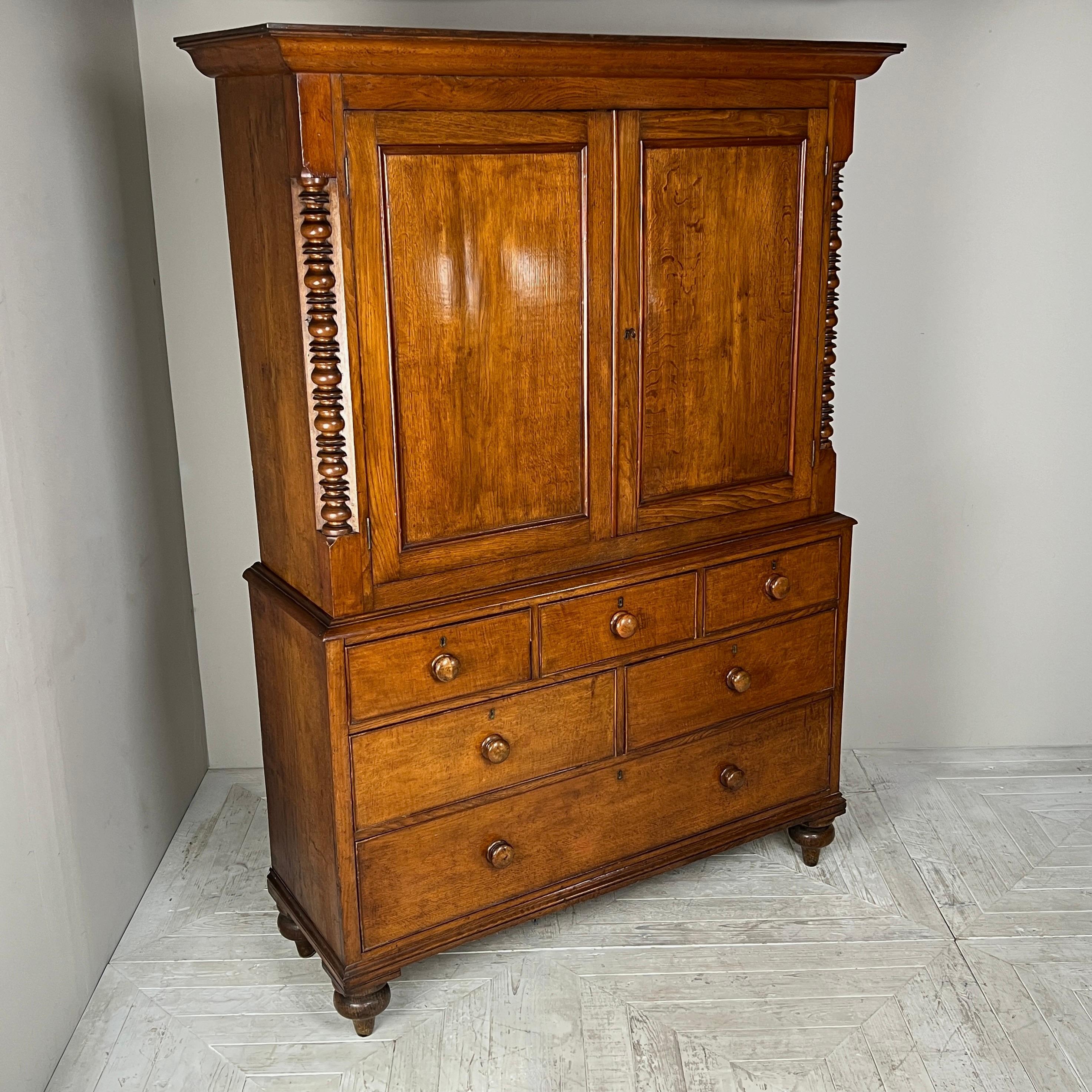 This is an exceptional 19th Century Welsh Oak Housekeeper's Cupboard, also known as a Linen Press, with a rich history, having remained in the same West Wales family for several generations. The piece is crowned by an elegant classical cornice,