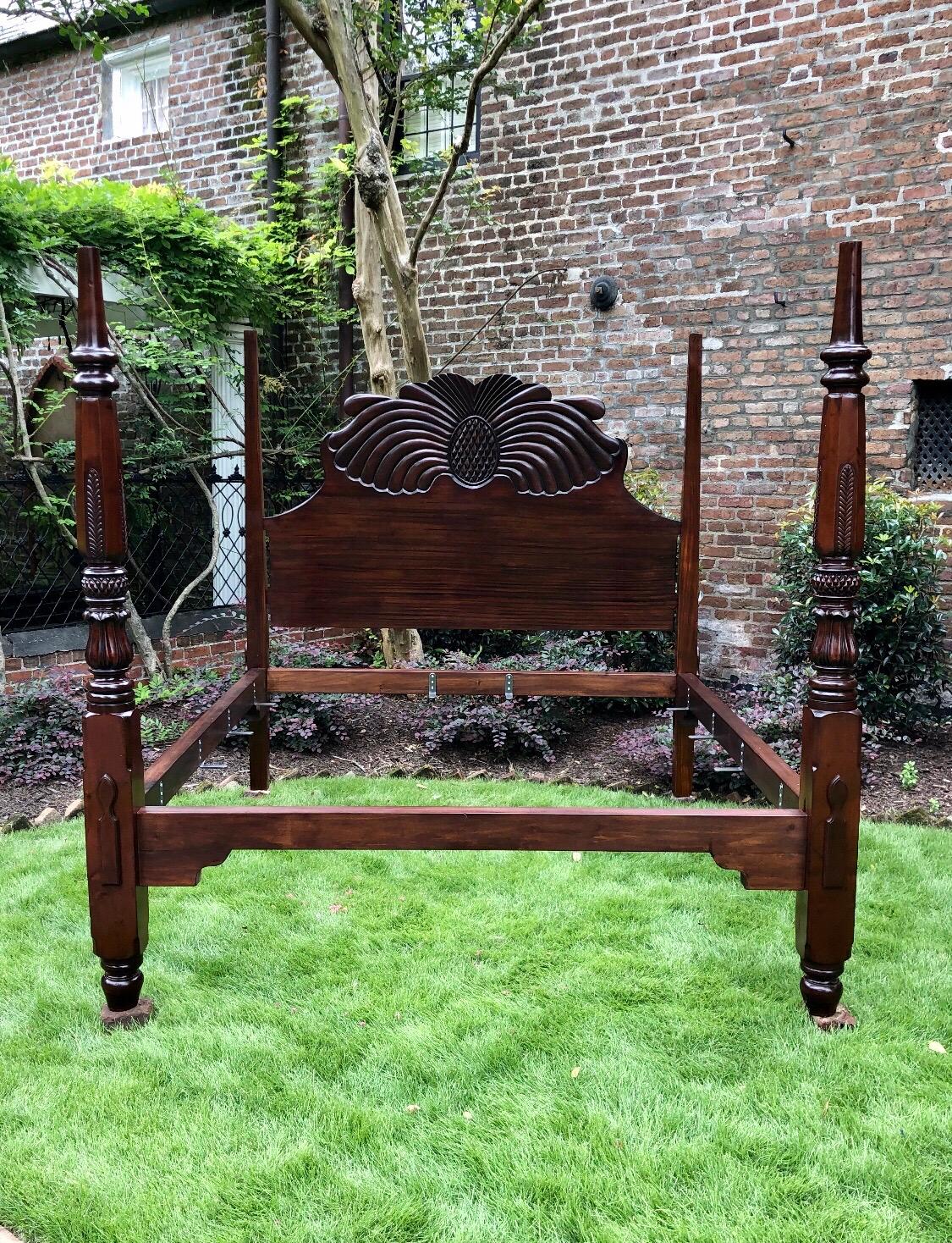 This exceptionally rare Jamaican pineapple bed is made of mahogany from the early 19th century. This Caribbean bedstead displays the less commonly used literal carved pineapple headboard sitting between two pencil head post. The artistic design of