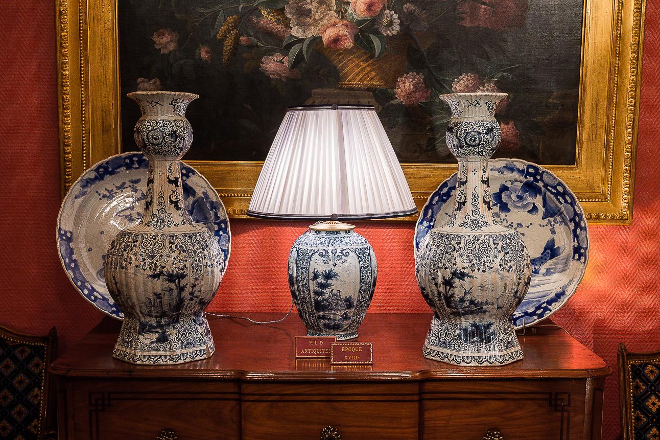 19th century white and blue Samson faience vase converted in table lamp.

A gorgeous white and blue Samson faience vase, decorated with a courteous scene, converted to a table lamp, with new French pleated silk lamp shade, white color.
Our vase