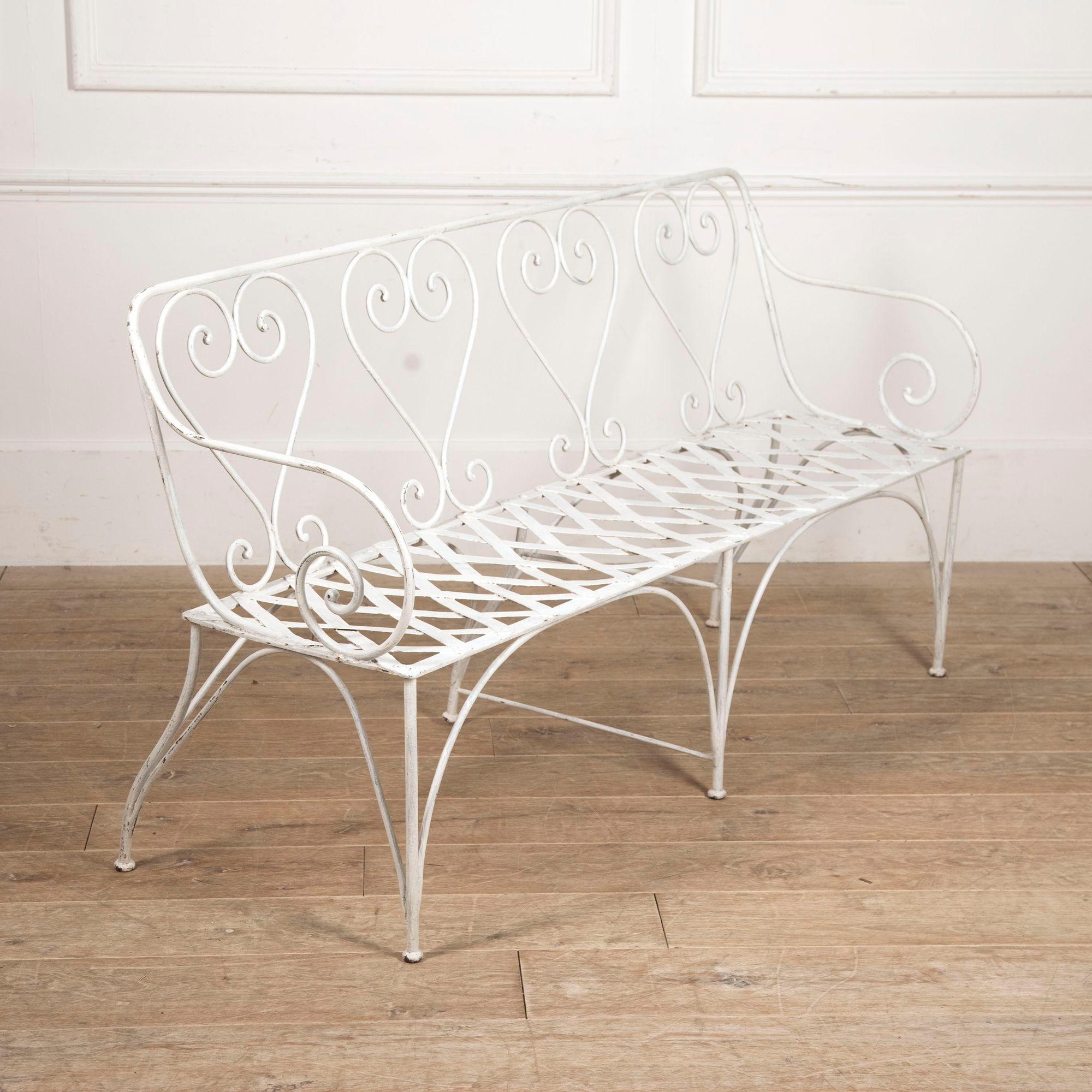 Lovely 19th Century French wrought iron garden seat, circa 1880.
This wonderful seat has heart-shaped motifs to the back and a flat iron latticed seat.
It is in excellent condition with remains of old white paint.