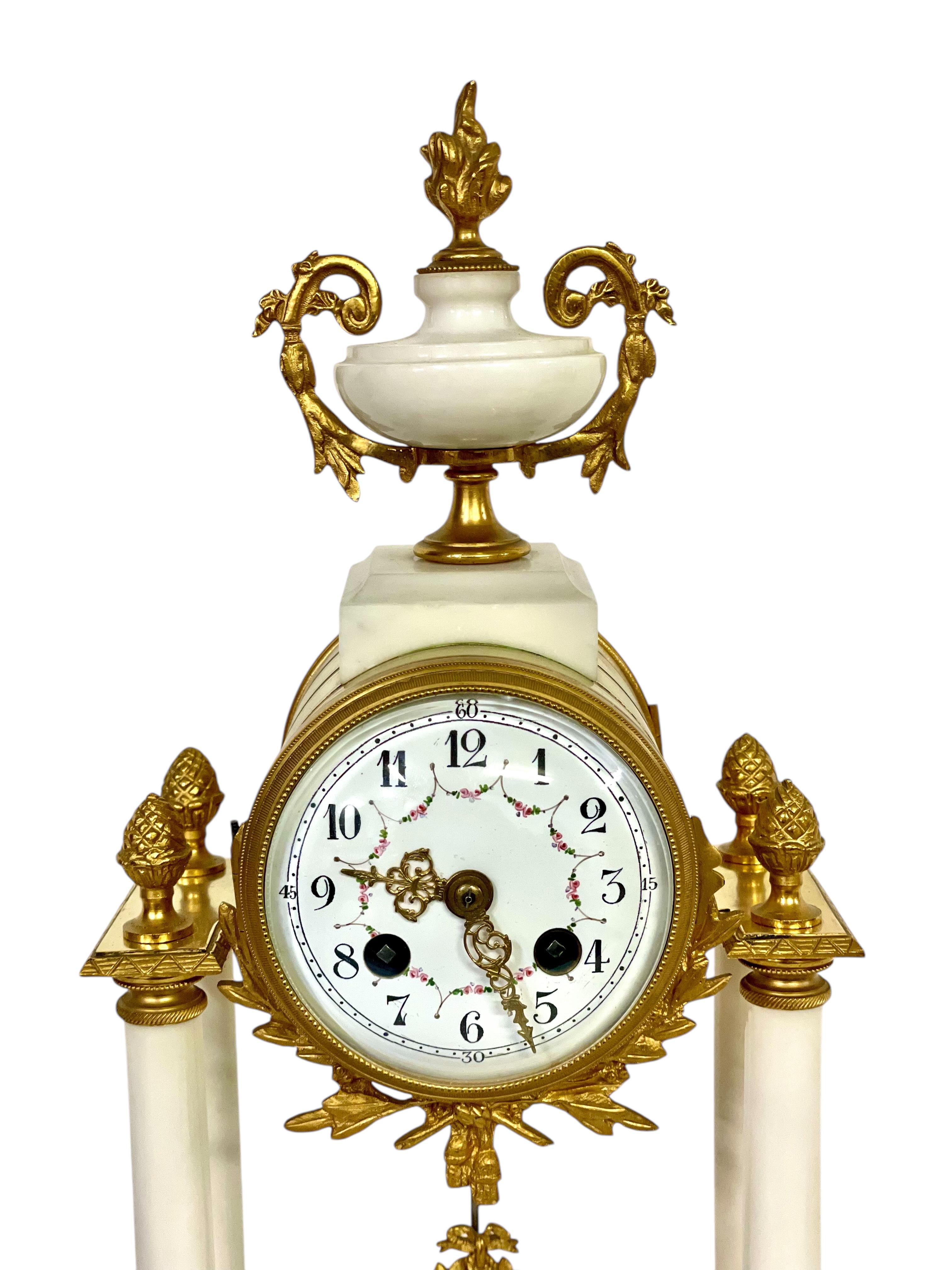 This stunning French mantel clock is a superb example of neoclassical design, showcasing the refinement and craftsmanship of the 19th century. Crafted from luxurious white marble, the clock is adorned with finely cast and gilded bronze ornaments,