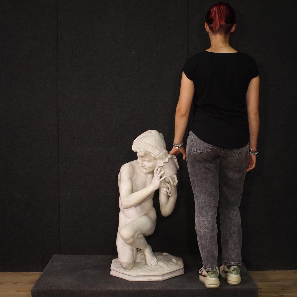 Large white marble statue from the second half of the 19th century. Sculpture of remarkable quality depicting a young Neapolitan fisherman who laughs mischievously while holding a shell to his ear. It features a signature 