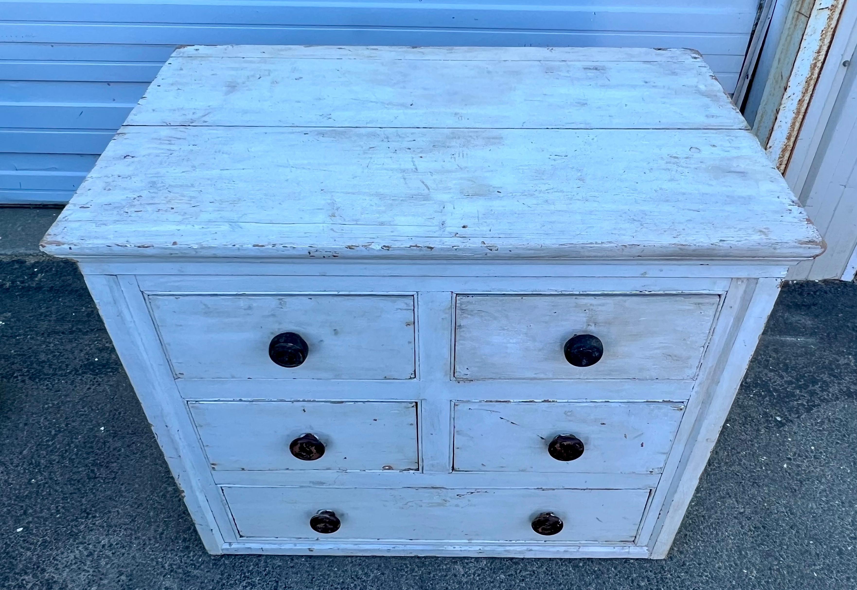 19th century chest of drawers in original white paint with turned, black-painted knobs.  With unusual two over two over one format.