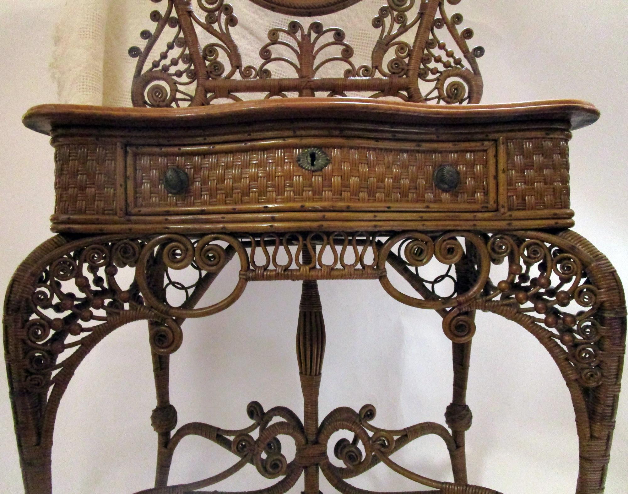 Of all the fanciful pieces of American wicker ever produced, this is the top of the line for advanced collectors. To find one in great condition and in natural stain is very unusual indeed. This sumptuous dressing stand vanity was featured in the