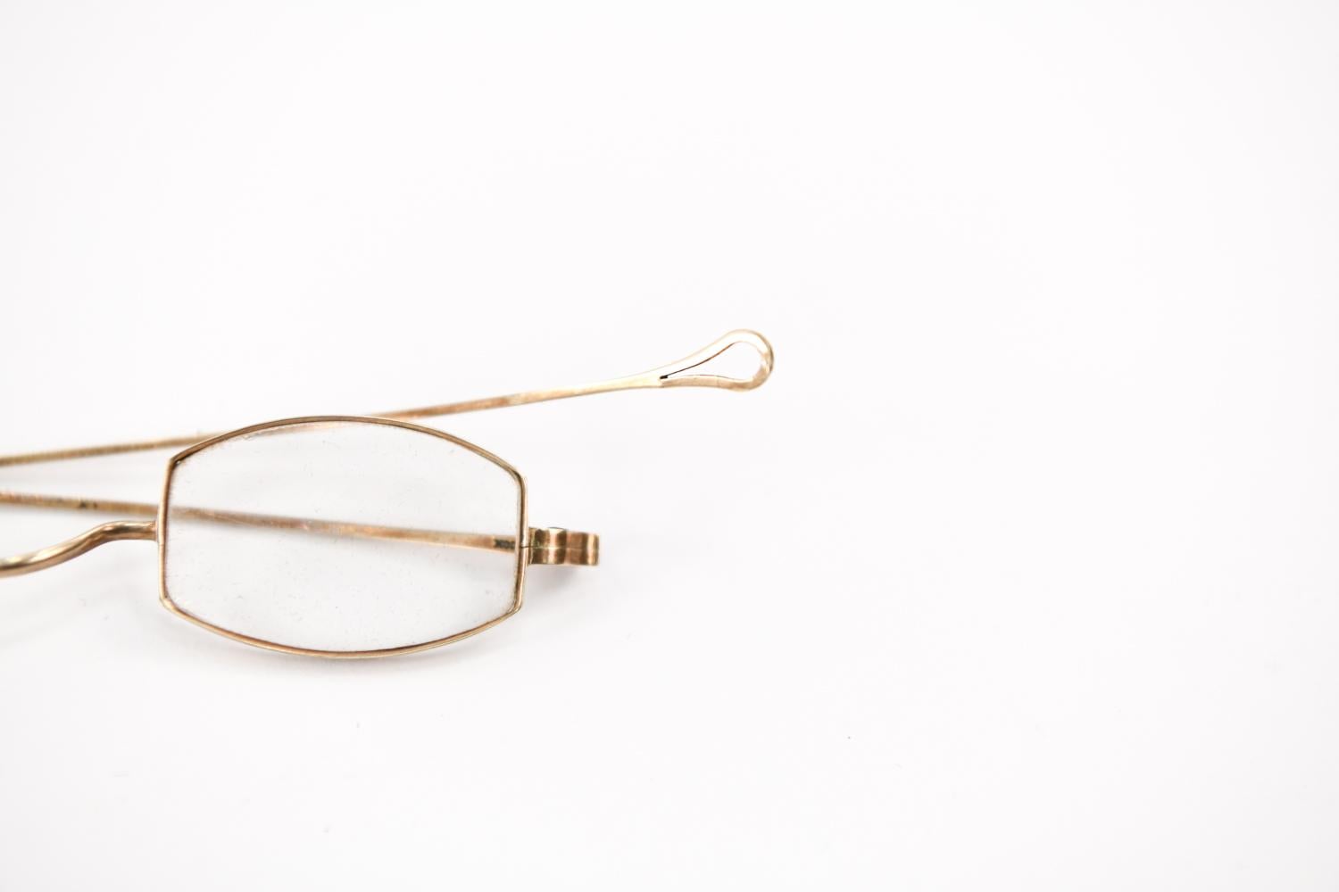 These exceptional antique spectacles feature solid 14K yellow gold wire-rim frames and a subtly rounded rectangular shape. The wire is stamped 