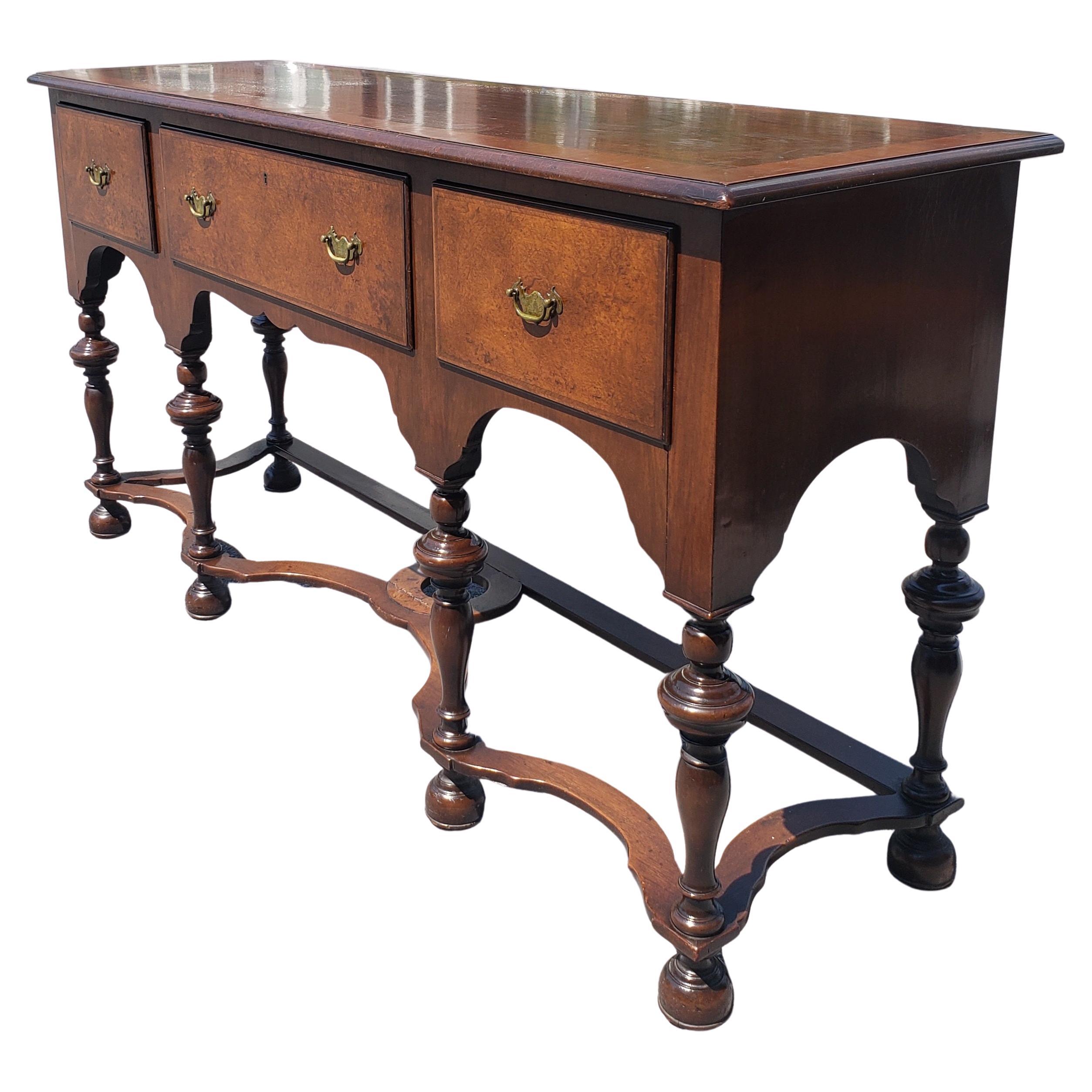 Beautifully patinated walnut burl and banded William and Mary sideboard / credenza / Buffet table. 
Features banded drawers and top, burl drawers doors. William and Mary turned legs with stretcher for greater stability and visual impact. Measures