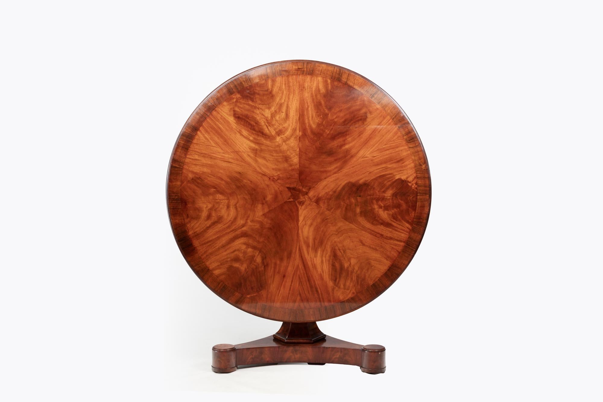 19th Century William IV feathered mahogany circular pod table with central inlaid star and crossbanding detail to the outer edge. The top sits above a pod platform base. Circa 1830.

Stamped Gillington with a registration number 9375.

The brothers