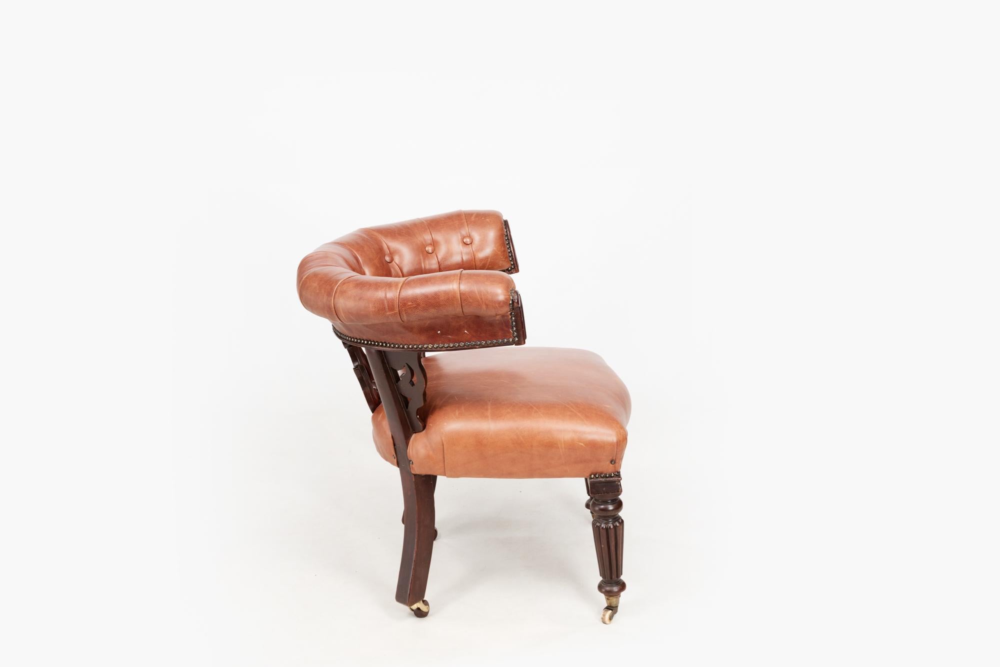 19th Century William IV mahogany Windsor chair. This bow back desk chair has been recovered with a tan leather button upholstered crest rail and seat. The carved splat features C-Scroll detailing, and the piece sits on turned and gadroon moulded