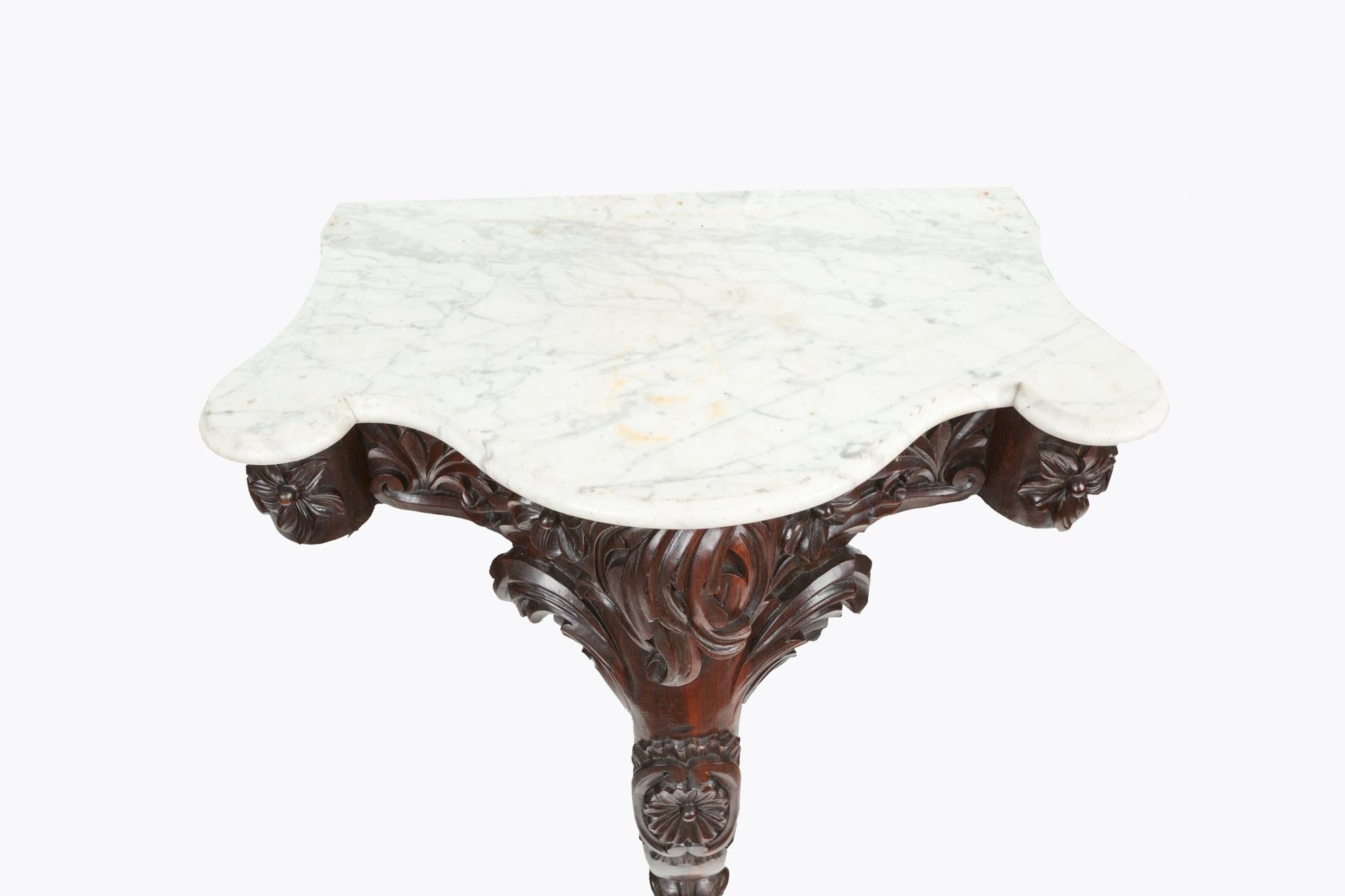 19th century William IV monopodia console table. Highly carved with acanthus and floral motif, with shaped marble top.

 