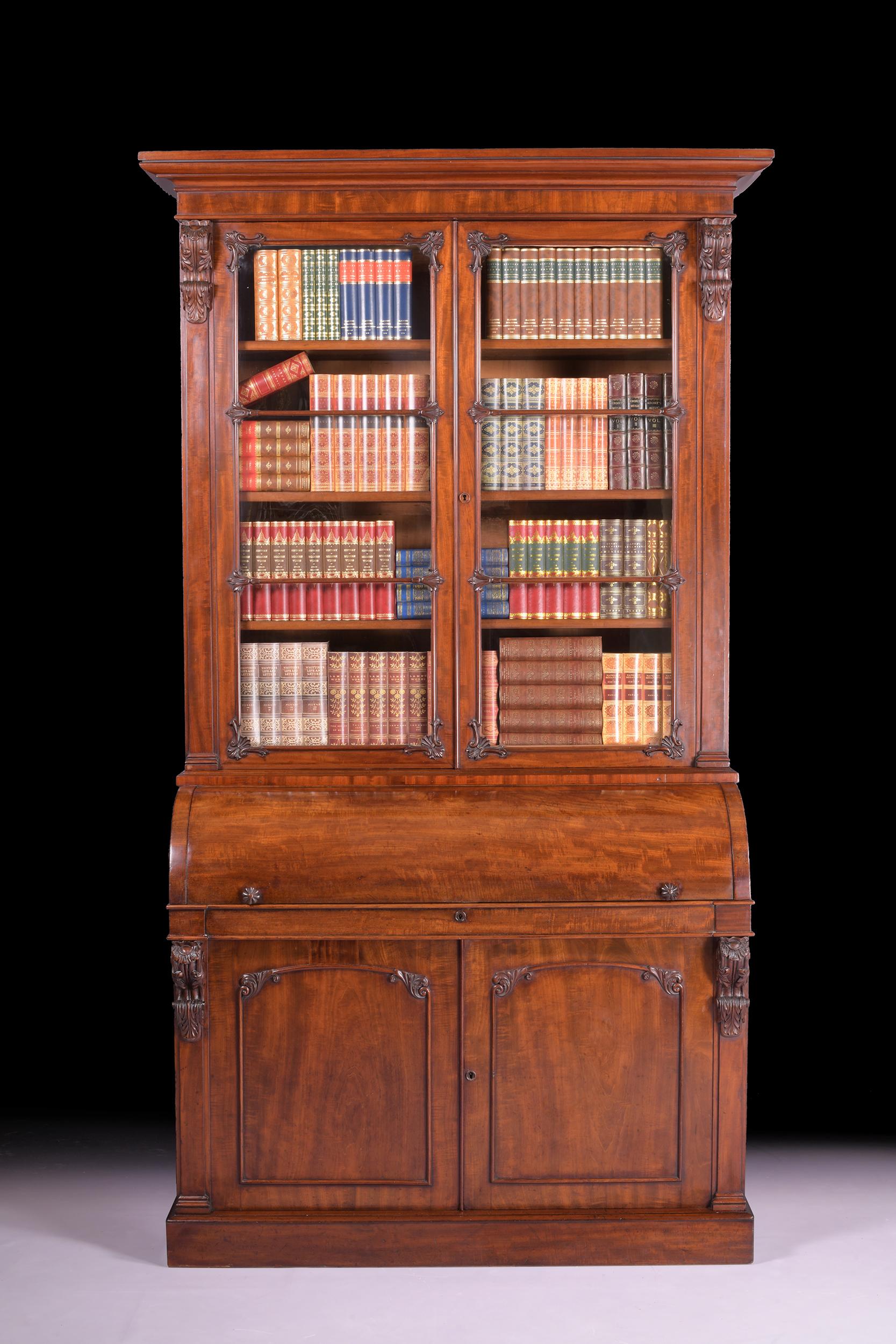 A stunning Irish William IV mahogany secretaire bookcase, the glazed doors enclosing shelves above the cylinder fall enclosing an arrangement of drawers and pigeonholes, and with cupboard doors to the base.

Circa 1835

Irish.