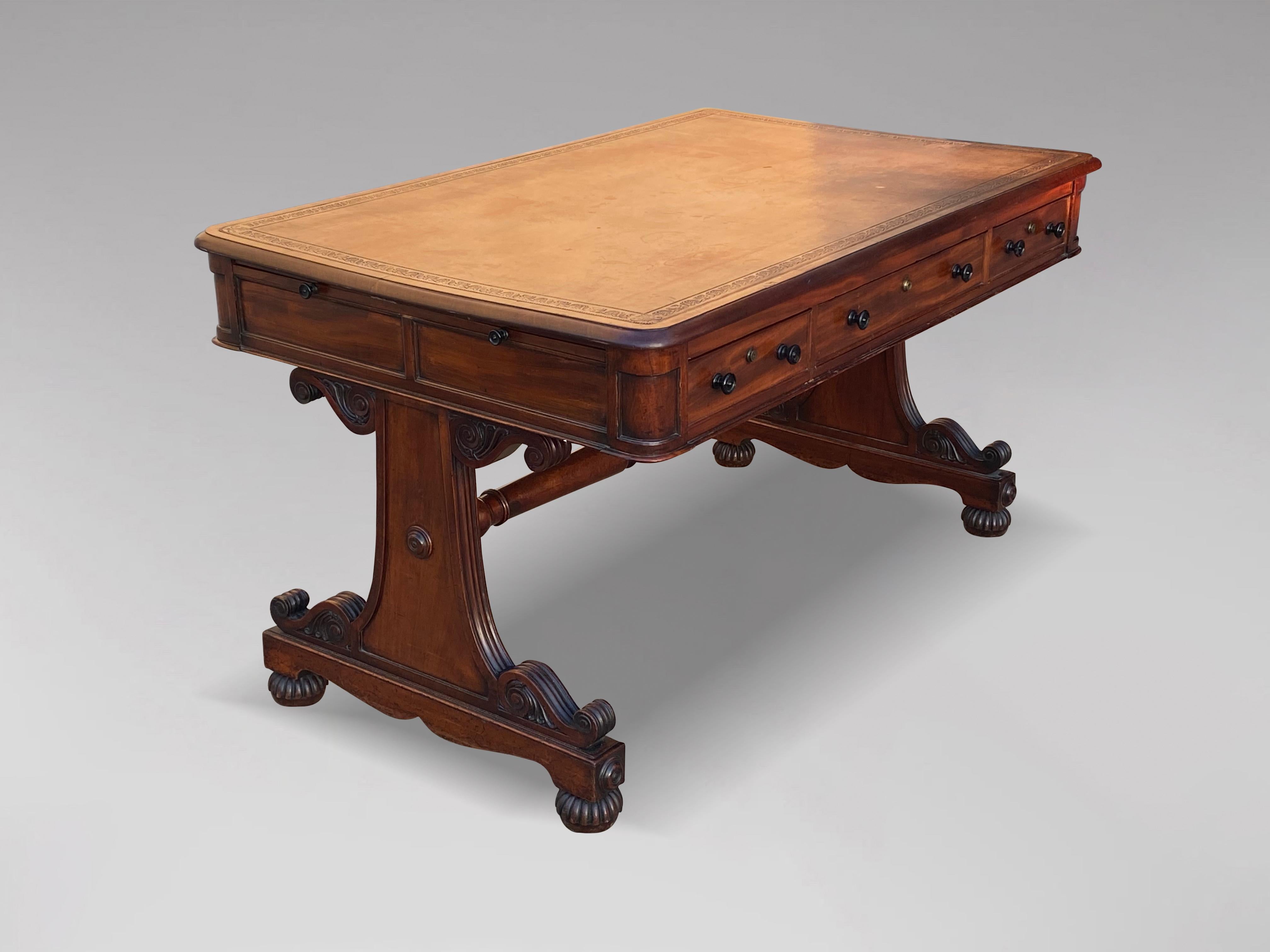 A stunning quality early 19th century William IV period mahogany partners writing table or library table. The moulded rectangular mahogany top with the original faded brown tooled leather top over three drawers on each side with sliding trays. Each