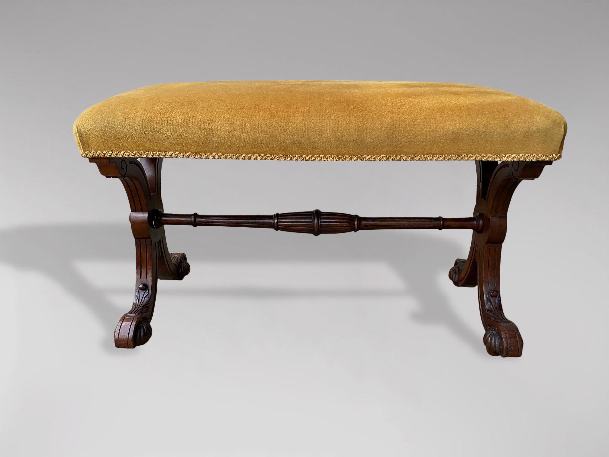 An exceptional 19th century, William IV period, mahogany X framed upholstered stool. Stuff over seat on scrolling cross supports, united with a turned stretcher, terminating on scrolled reeded bun feet with castors.

The dimensions are:
Height: 52cm
