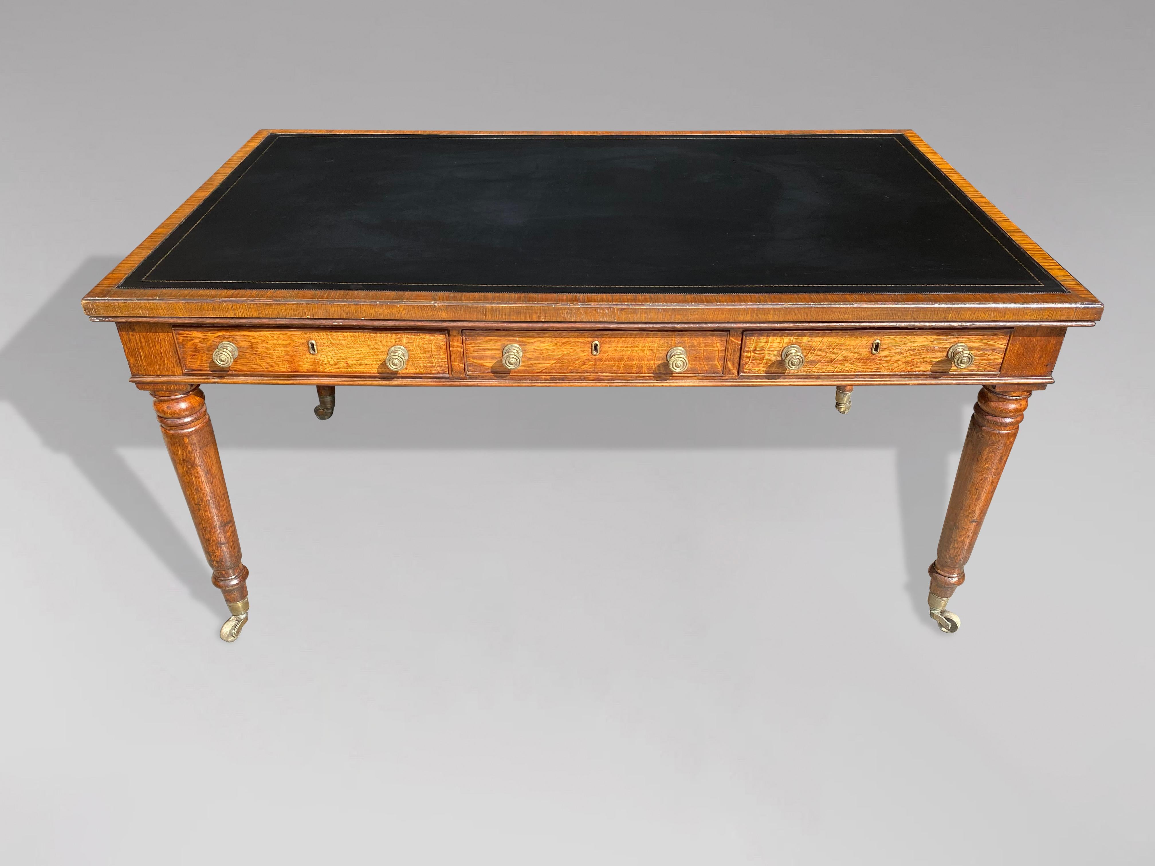 A stunning quality, 19th century, William IV period oak partners library writing table. The moulded rectangular top with a superb quality new black tooled leather inset top above 6 drawers with turned brass knobs, raised on 4 slender turned legs