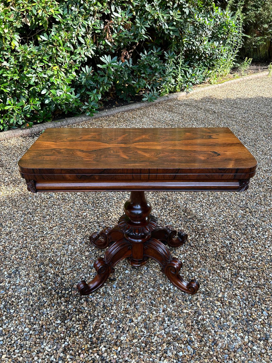 A very high quality 19th Century William IV Rosewood Card Table with baize interior. With turned and carved column support, four well carved scroll and shaped cabriole legs with original castors. The top rotates by 90 degrees and unfolds to convert