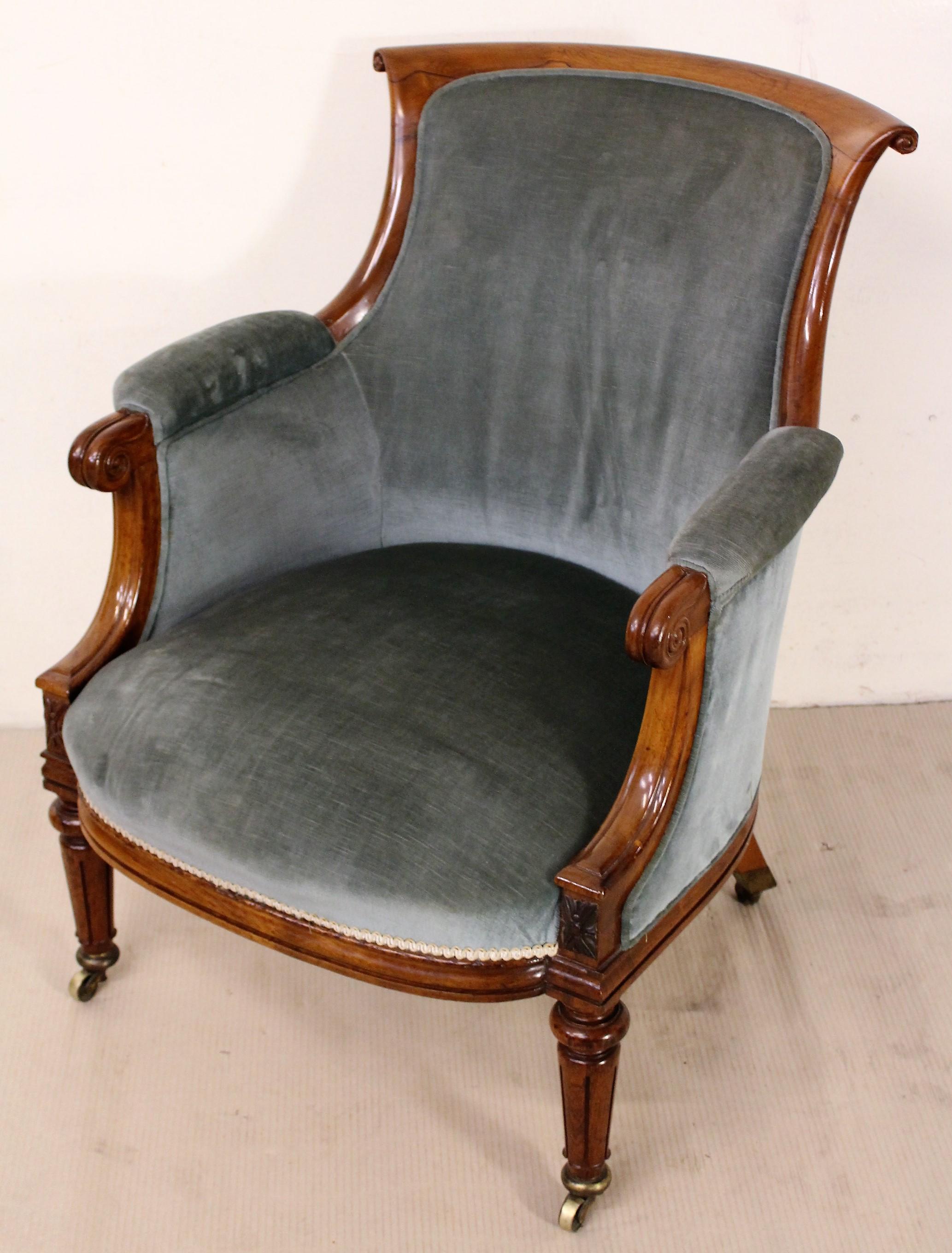 A splendid William IV period bergere library upholstered armchair. Of fine construction in solid rosewood with attractive rosewood veneers. With scrolling arms and charming fluted legs which terminate in their original brass caps and castors.