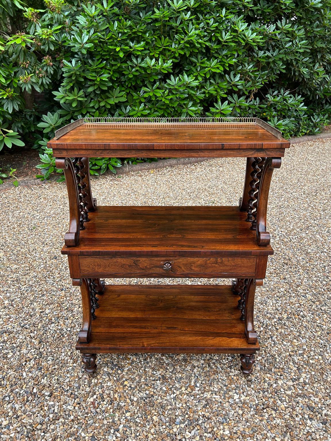 19th Century William IV Rosewood Whatnot, with brass gallery, over three tiers raised on turned spiral barley twist rosewood uprights, with a drawer to one shelf, all standing on turned carved legs and castors.

Circa: 1835

Dimensions:
Height:  38
