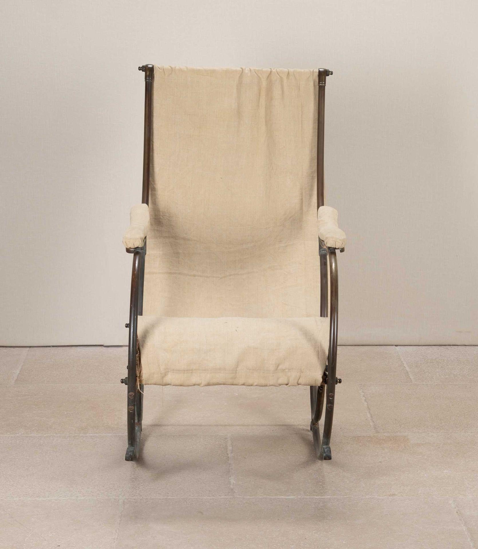 19th Century brass framed rocking chair attributed to R.W.Winfield. 
Loosely upholstered in plain calico.