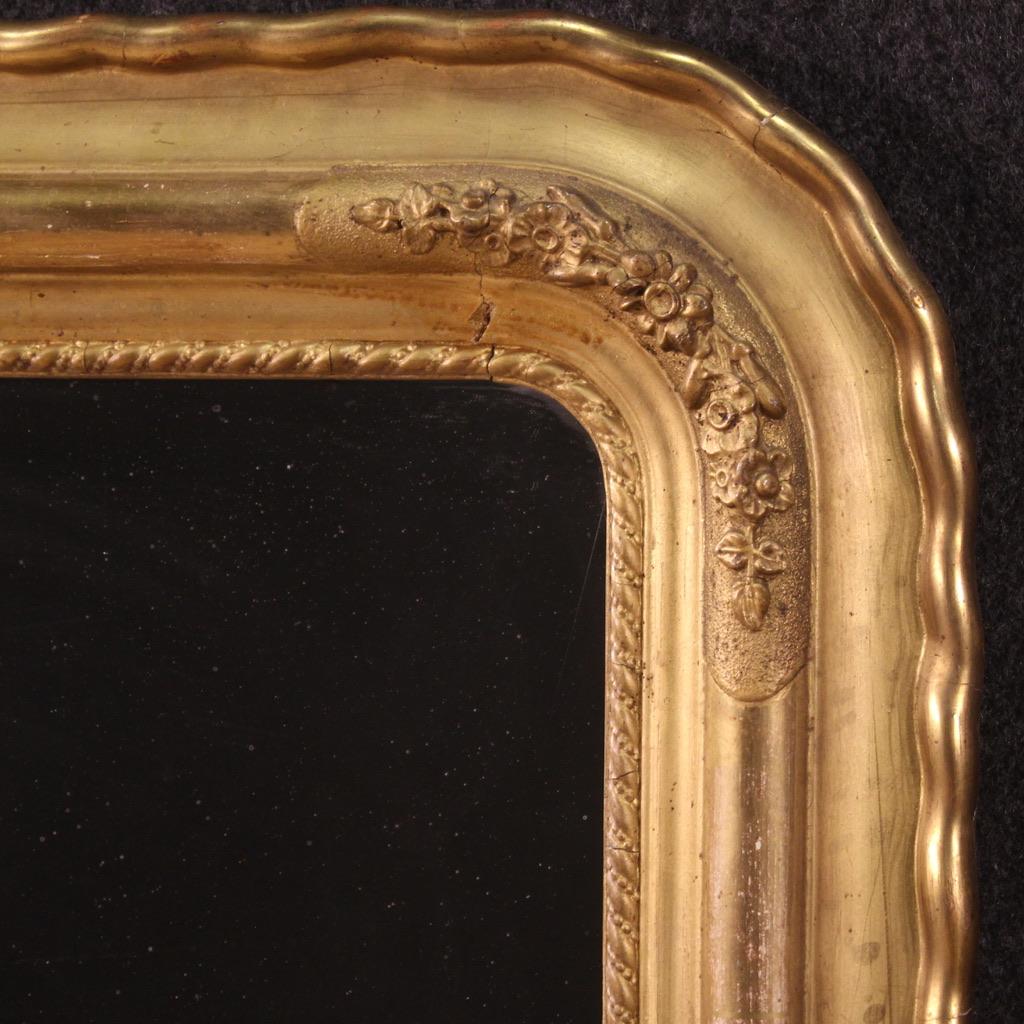 Italian mirror from the second half of the 19th century. Pleasantly carved and gilded wood and plaster furniture adorned with floral decorations. Non-original mirror, mirrored glass with some signs of wear replaced during the second half of the 20th