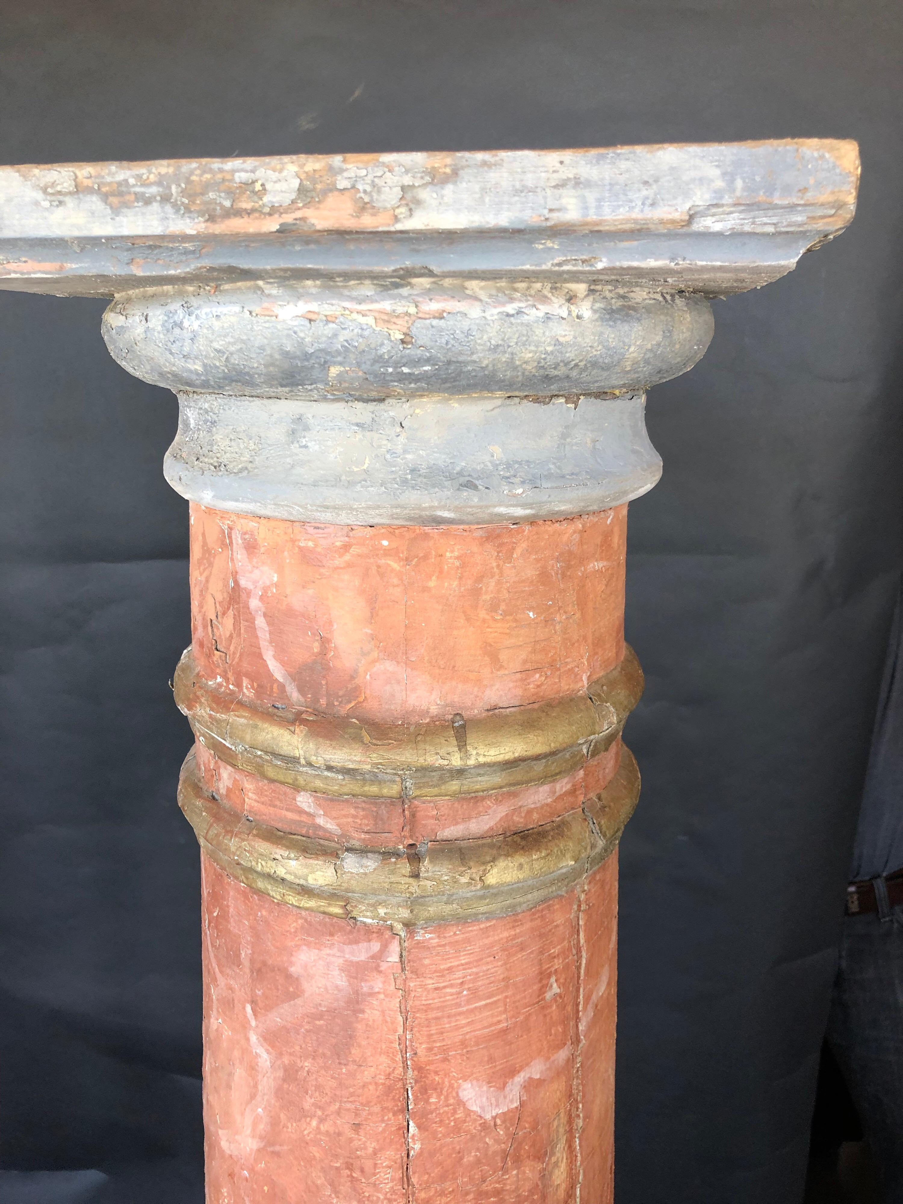 A striking pair of architectural columns in faux terracotta. Base is approximately 11 inches in diameter. Top is 12