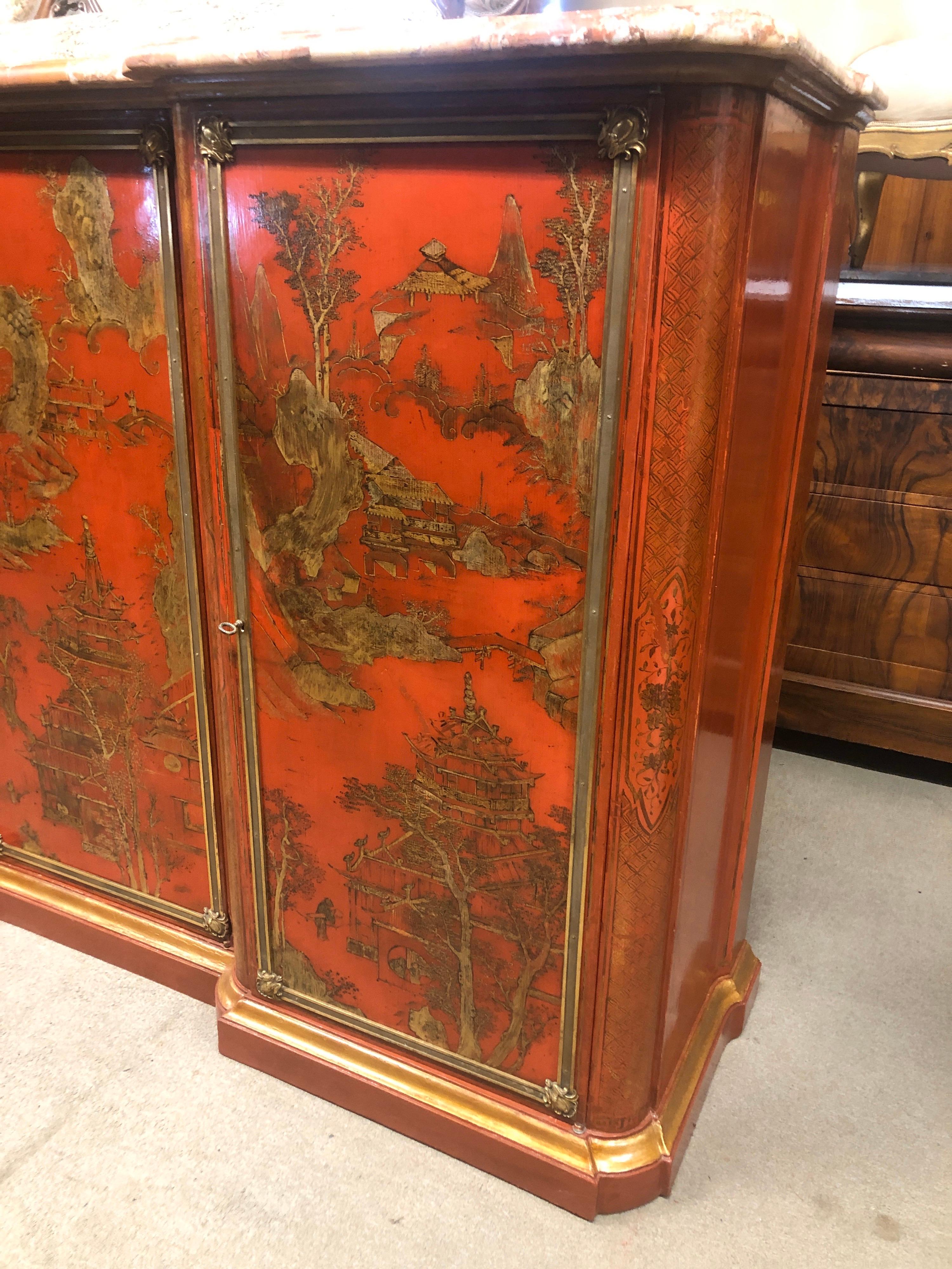 French sideboard, Napoleon III period, circa 1860, lacquered in red with gold Chinoiserie designs, original bronzes framing the three doors, the sideboard is moved on the sides, the marble has a restoration. Inside (completely in solid oak like the